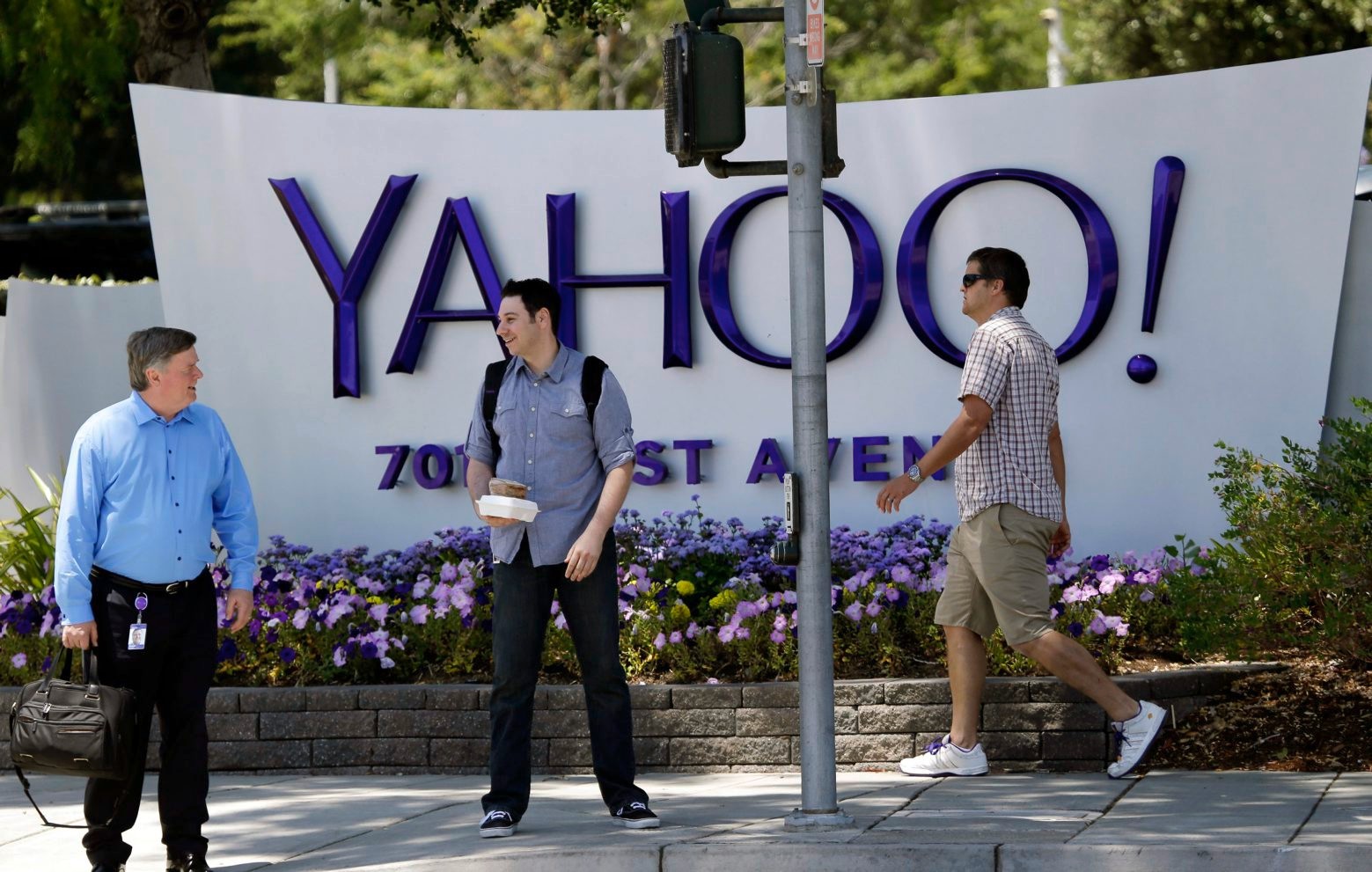 FILE - In this June 5, 2014, file photo, people walk in front of a Yahoo sign at the company's headquarters in Sunnyvale, Calif. Yahoo says the personal information of 500 million accounts have been stolen in a massive security breakdown that represents the latest setback for the beleaguered internet company. The breach disclosed on Thursday, Sept. 22, 2016, dates back to late 2014. Yahoo is blaming the hack on a Äústate-sponsored actor.Äù (AP Photo/Marcio Jose Sanchez, File) Yahoo Breach