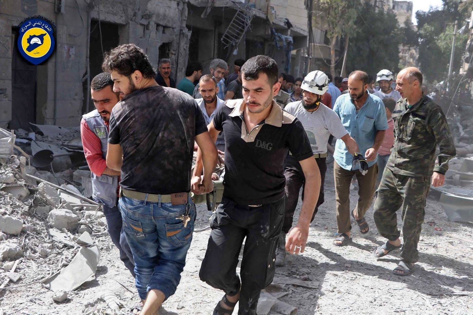 In this photo provided by the Syrian Civil Defense White Helmets, rescue workers work the site of airstrikes in al-Mashhad neighborhood in the rebel-held part of eastern Aleppo, Syria, Wednesday Sept. 21, 2016. Ibrahim Alhaj, a member of the volunteer first responders known as the Syria Civil Defense, said 24 people were killed in a series of bombings in several parts of the besieged city Aleppo on Wednesday. (Syrian Civil Defense White Helmets via AP) Mideast Syria