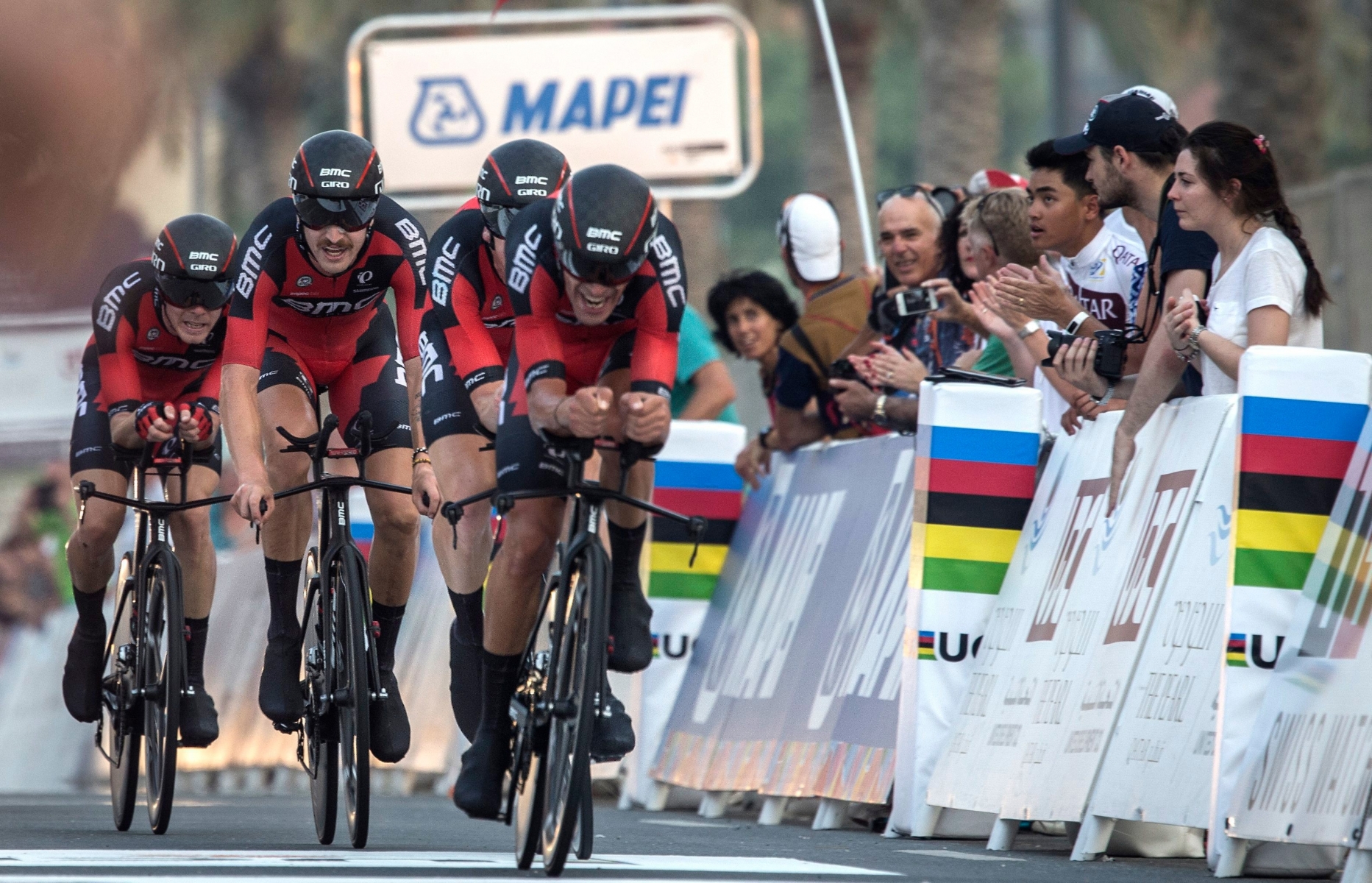 epa05578156 Cyclists of the US American BMC Racing Team team cross the finish line to finish second in the Men's Team Time Trial event during the 2016 cycling Road Wolrd Championships in Qatar, Doha, 09 October 2016.  EPA/OLIVER WEIKEN QATAR ROAD CYCLING WORLD CHAMPIONSHIPS 2016