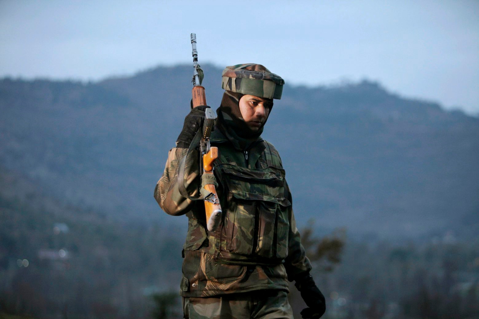 An Indian army soldier patrols near the line of control, the line that divides Kashmir between India and Pakistan, after a reported cease-fire violation, in Mendhar, Poonch district, about 210 kilometers (131 miles) from Jammu, India, Wednesday, Jan. 9, 2013. An Indian army official said Pakistani soldiers crossed the cease-fire line in the disputed Himalayan region of Kashmir and attacked an Indian army patrol, killing two Indian soldiers. While the two nations remain rivals, relations between them have improved dramatically since the 2008 Mumbai siege, in which 10 Pakistani gunmen killed 166 people and effectively shut down the city for days. (AP Photo/Channi Anand) India Pakistan Shooting