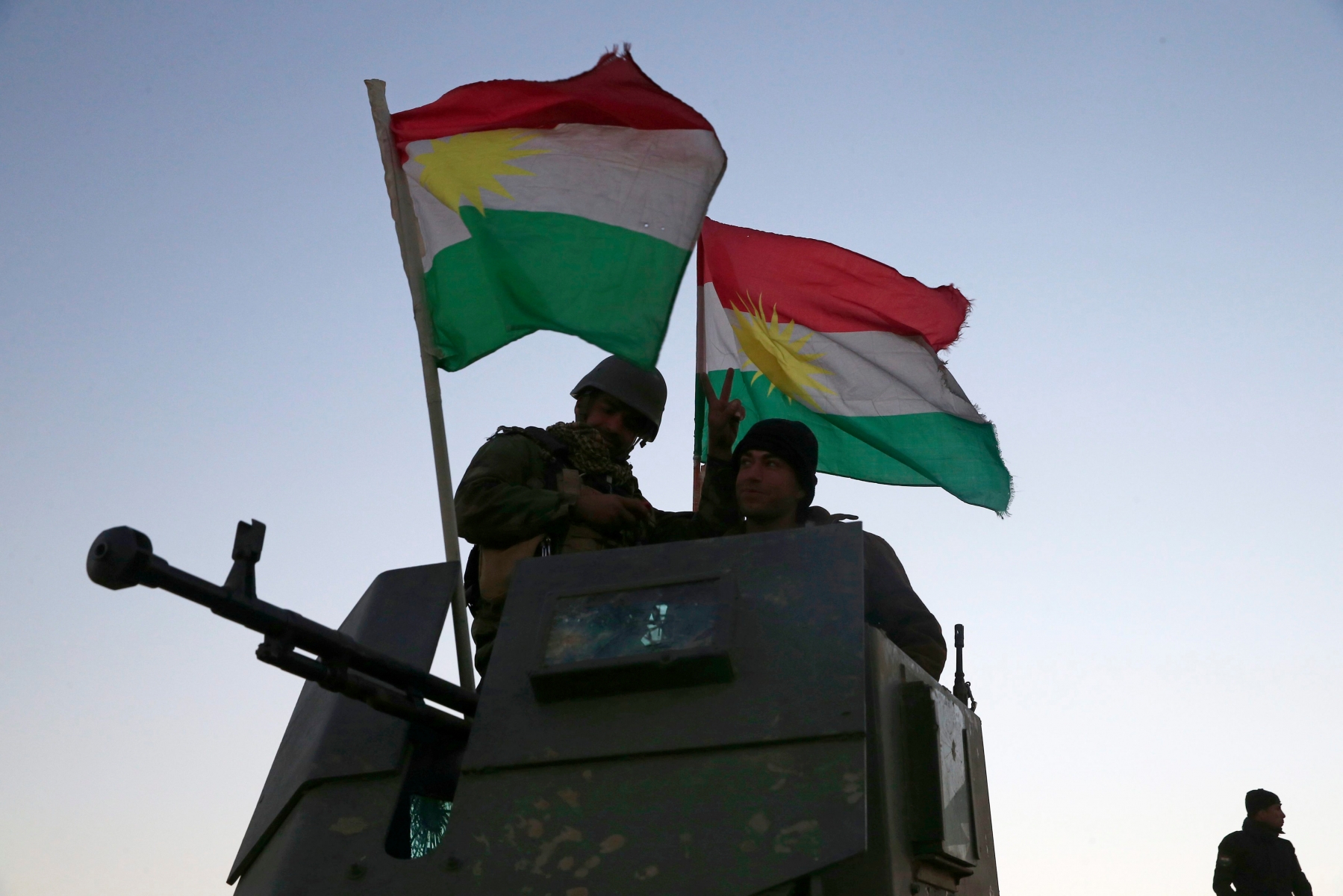Kurdish Peshmerga fighters stand on top of a military vehicle as they advance towards villages surrounding Mosul, in Khazer, about 30 kilometers (19 miles) east of Mosul, Iraq, Monday, Oct. 17, 2016. The Iraqi military and the country's Kurdish forces say they launched operations to the south and east of militant-held Mosul early Monday morning. (AP Photo/Bram Janssen) Mideast Iraq