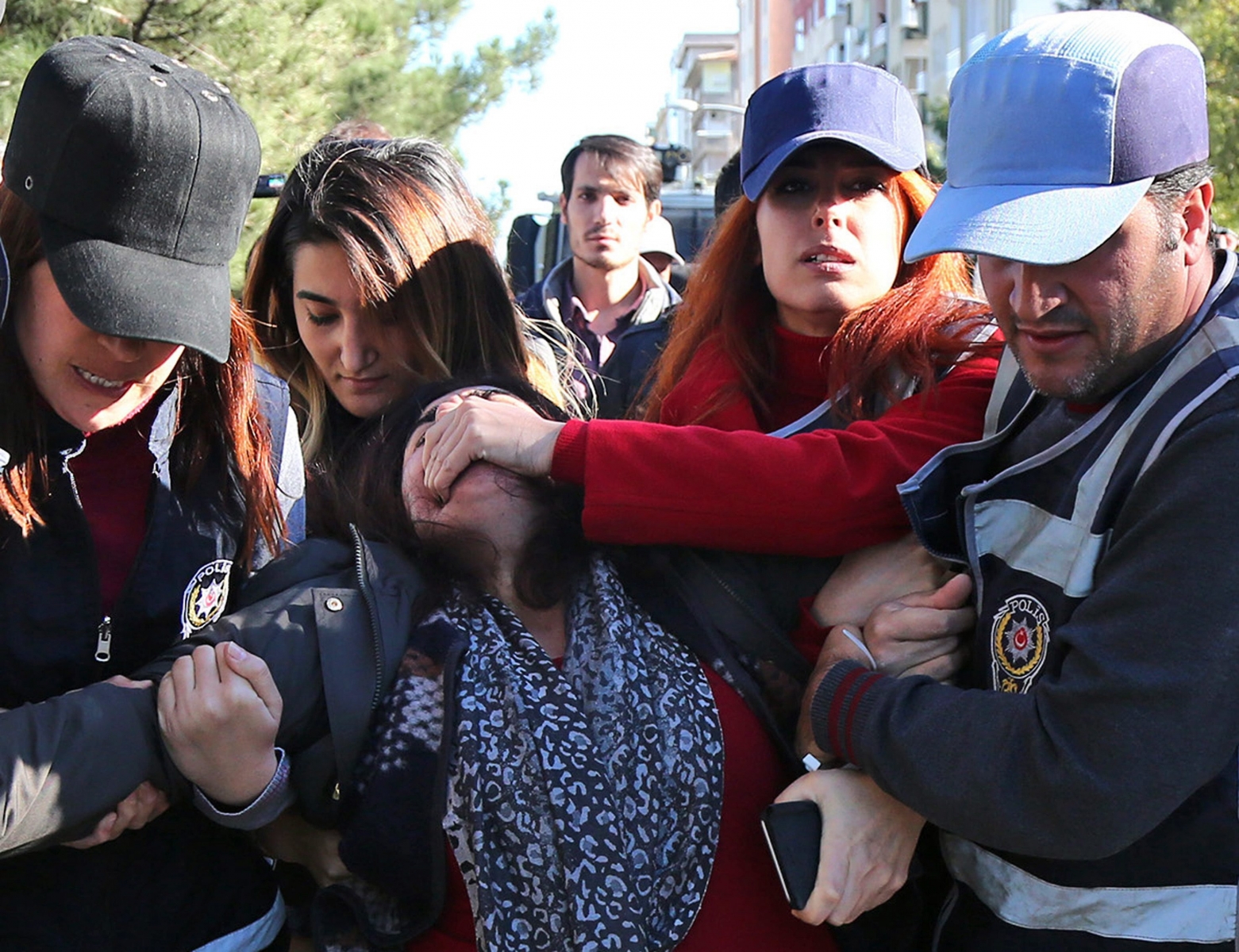 epa05617513 Plainclothed Turkish police hold the mouth shut of former Kurdish parliamentarian Sebahat Tuncel (C) as they arrest her during a anti-government protest in Diyarbakir, Turkey, 04 November 2016. Co-leaders of the pro-Kurdish and pro-minority political party Peoples' Democratic Party (HDP) Figen Yuksekdag and Selahattin Demirtas were detained, along with at least nine other members of parliament (MPs), as part of a counter-terrorism investigation following a police raid in the HDP party headquarters. The HDP is accused by the Turkish government to have links with the Kurdistan Workers' Party (PKK) militant group, an accusation HDP strongly denies  EPA/STR TURKEY POLITICS PARTIES PROTEST