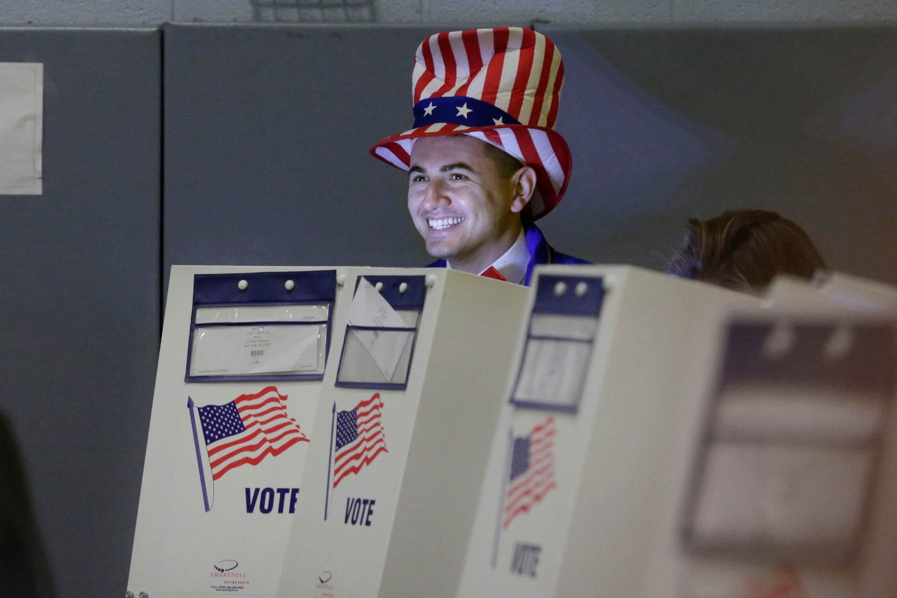 Travis Lopes, dressed in a patriotic outfit, votes in the polling place of Republican presidential candidate Donald Trump in New York, Tuesday, Nov. 8, 2016. (AP Photo/Richard Drew) Election 2016 Trump