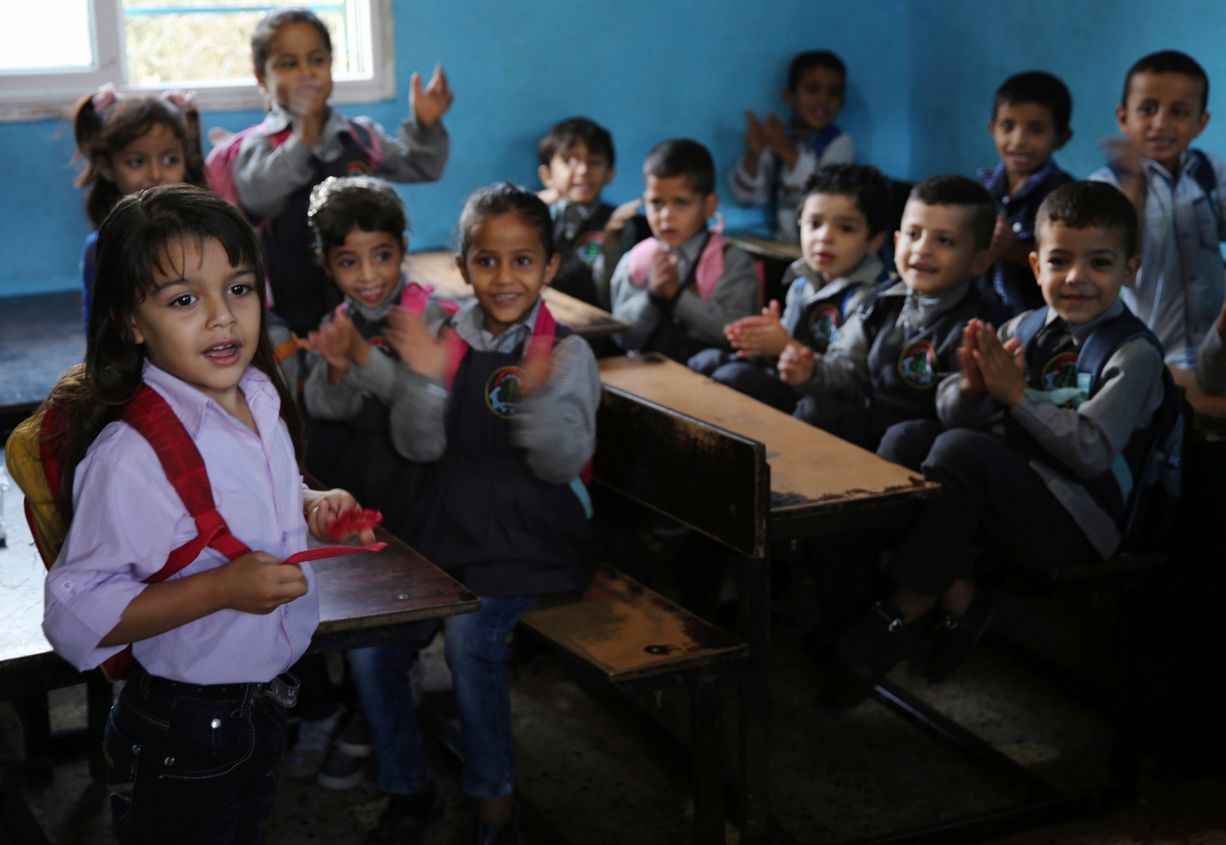 In this Oct. 31, 2016 photo, Abdel Ghani al-Attar, left, recites poetry to his classmates at a kindergarten in Rafah, Gaza. Like millions of Syrians, the al-Attar family fled the civil war in his homeland in search of safety and security, but in a decision they now regret, they chose to go to Gaza. Their family is among 12 Syrian households that found refuge in Gaza after the civil war erupted in 2011 and are now trapped in the war-battered territory, but also unable to travel abroad. (AP Photo/Adel Hana) Mideast Palestinians Syrians in Gaza