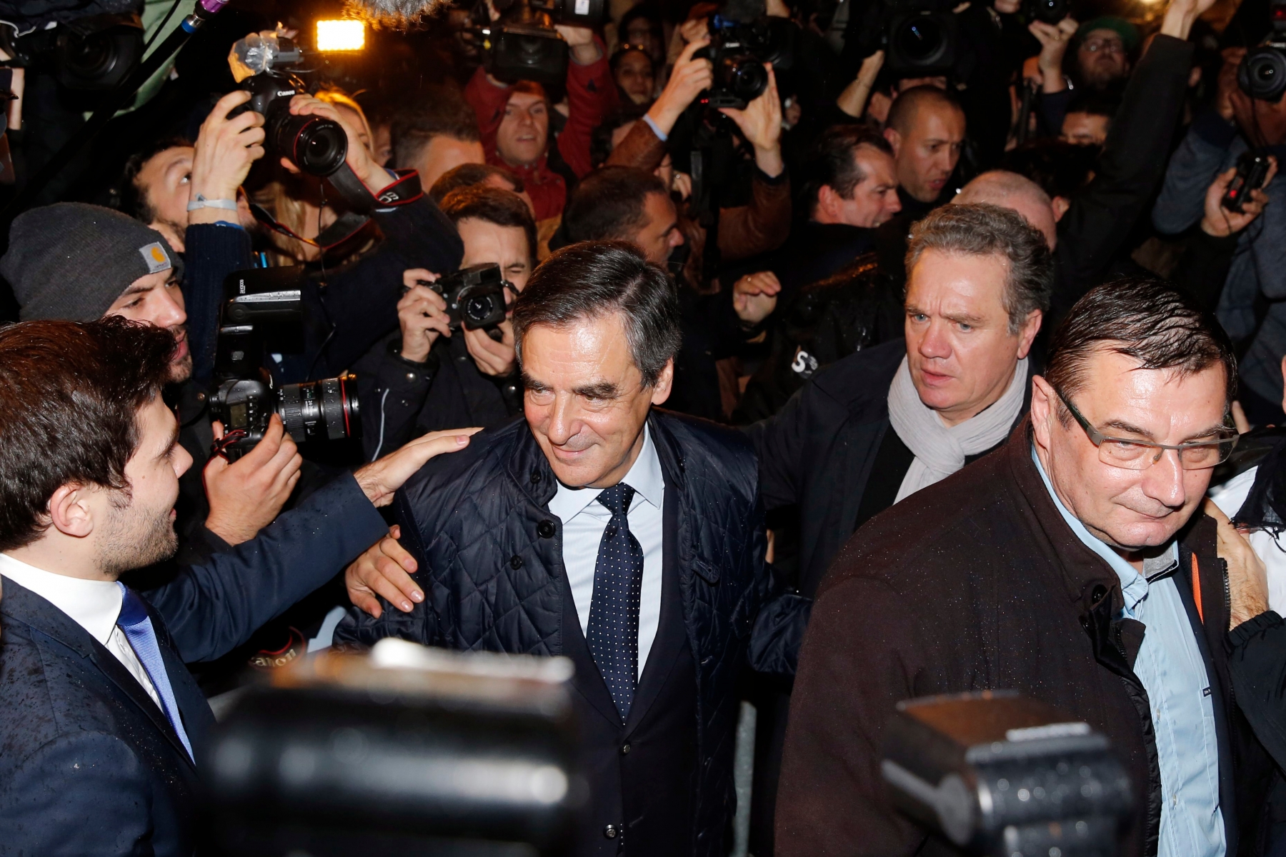 Candidate for the right-wing Les Republicains (LR) party primaries ahead of the 2017 presidential election and former French prime minister, Francois Fillon, center left, arrives at his campaign headquarters after the vote's first round, on November 20, 2016 in Paris. on Sunday, Nov. 20, 2016. Francois Fillon had the largest share of votes in early returns Sunday from the first round of the conservative primary for next year's presidential election. (Gonzalo Fuentes/Pool Photo via AP) France Election