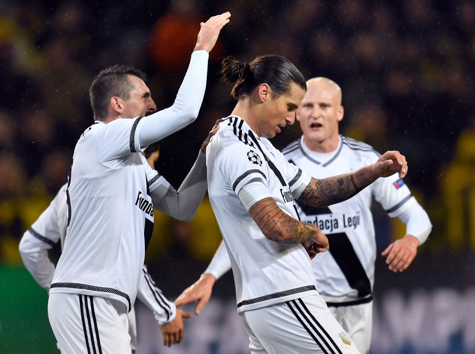 Legia's scorer Aleksandar Prijovic, center, and his teammates celebrate the opening goal during the Champions League Group F soccer match between Borussia Dortmund and Legia Warsaw in Dortmund, Germany, Tuesday, Nov. 22, 2016. (AP Photo/Martin Meissner) Germany Soccer Champions League