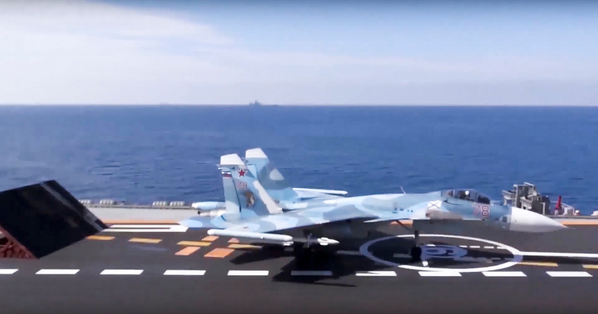 In this photo made from the footage taken from Russian Defense Ministry official web site on Tuesday, Nov. 15, 2016, a Russian Su-33 fighter jet stands ready for takeoff on the flight deck of the Admiral Kuznetsov aircraft carrier in the eastern Mediterranean Sea. The Russian military on Tuesday launched a series of strikes on militant targets in Syria involving carrier-borne fighters, marking the Admiral Kuznetsov's combat debut. (Russian Defense Ministry Press Service/ Photo via AP) RUSSIA MILITARY MODERNIZATION