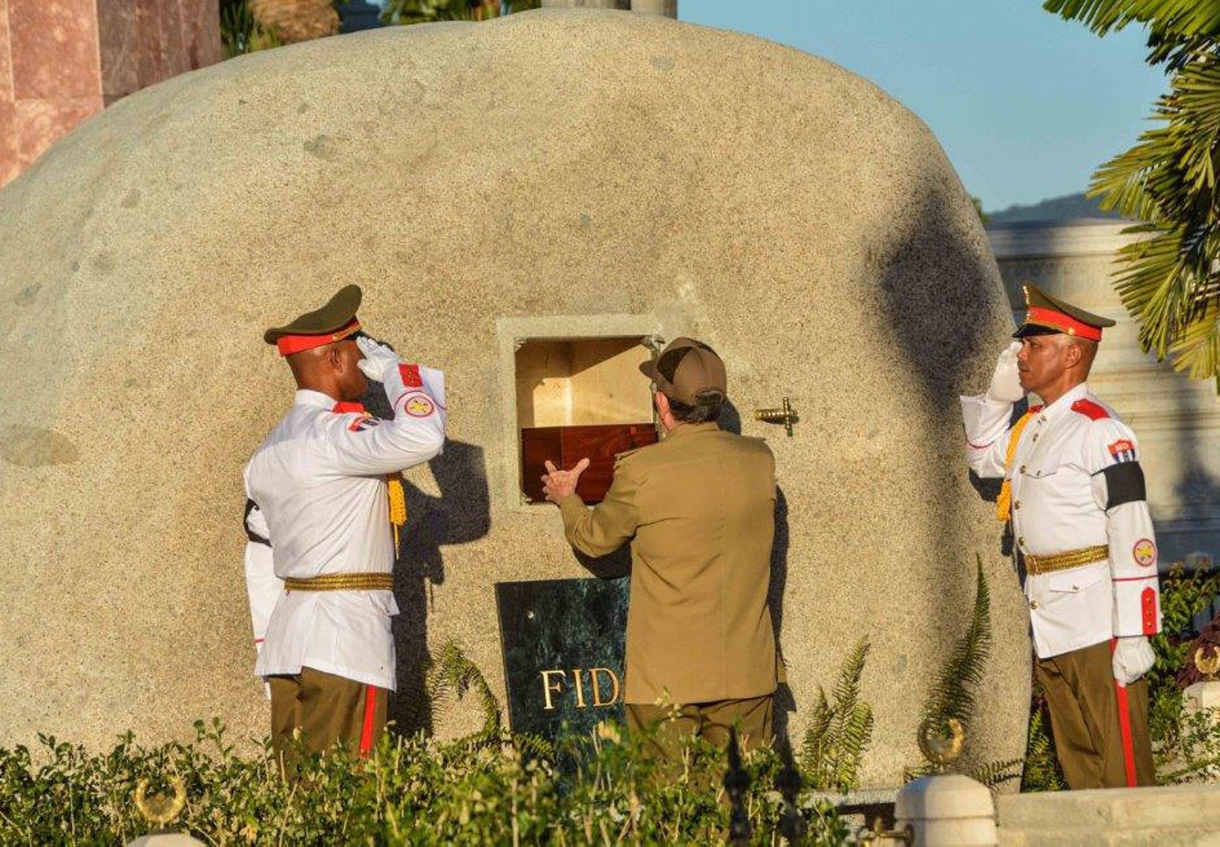 Cuba's President Raul Castro places the ashes of his older brother Fidel Castro into a niche in his tomb, a simple, grey, round stone about 15 feet high at the Santa Ifigenia cemetery in Santiago, Cuba, Sunday Dec.4, 2016. The niche was then covered by a plaque bearing the single name,"Fidel."(Marcelino Vazquez Hernandez/Pool Photo via AP) Cuba Fidel Castro