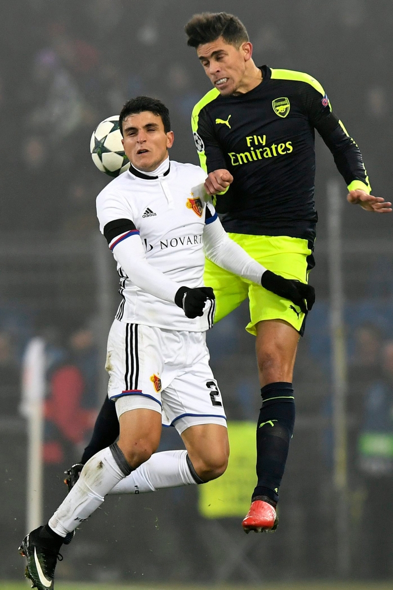 Basel's Mohamed Elyounoussi, left, fights for the ball against Arsenal's Gabriel, right, during an UEFA Champions League Group stage Group A matchday 6 soccer match between Switzerland's FC Basel 1893 and England's Arsenal FC in the St. Jakob-Park stadium in Basel, Switzerland, on Tuesday, December 6, 2016. (KEYSTONE/Walter Bieri) SWITZERLAND SOCCER CHAMPIONS LEAGUE BASEL ARSENAL