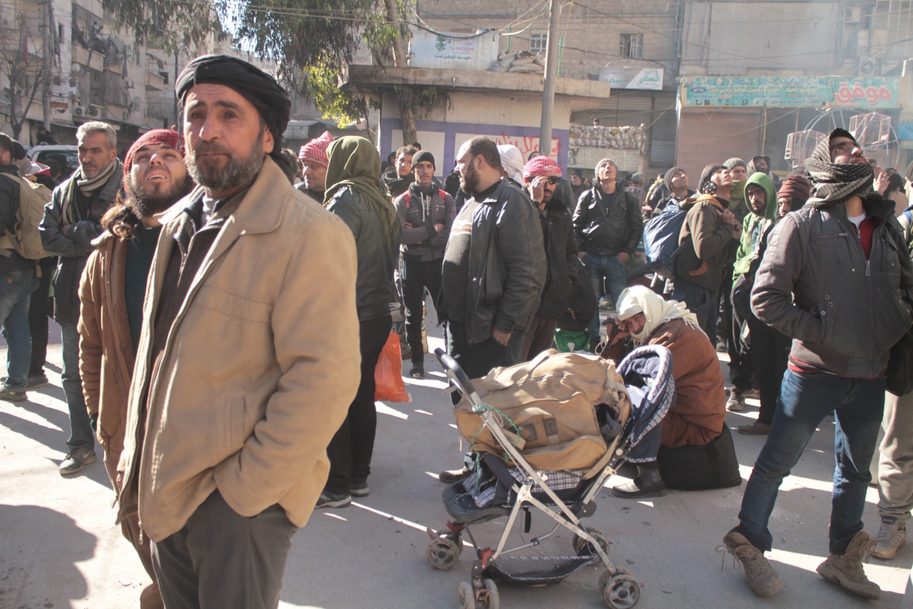epa05677965 People wait in the street during the evacuation, Aleppo, Syria, 15 December 2016 (issued 16 December 2016). Evacuation of civilians from the rebel-held parts of Aleppo was suspended according to news reports on 16 December 2016. Aleppo's residents have been under siege for weeks and have suffered bombardment, together with chronic food and fuel shortages.  EPA/GHITH SY SYRIA ALEPPO EVACUATION