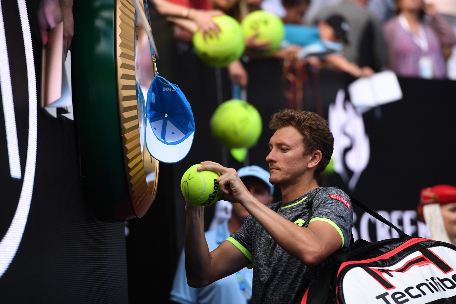 epa05729939 Denis Istomin signs autographs after defeating Novak Djokovic of Serbia in round two of the Menís Singles at the Australian Open Grand Slam tennis tournament in Melbourne, Victoria, Australia, 19 January 2017.  EPA/TRACEY NEARMY AUSTRALIA AND NEW ZEALAND OUT AUSTRALIA TENNIS AUSTRALIAN OPEN GRAND SLAM