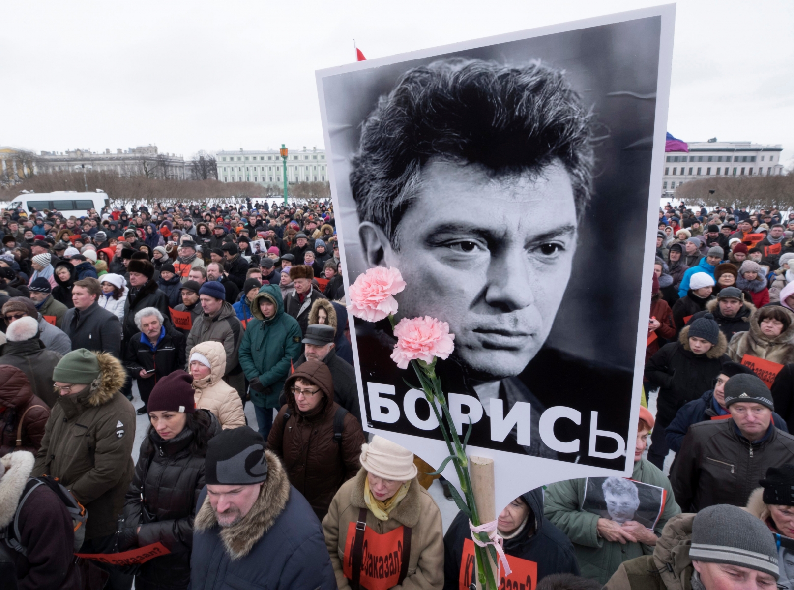 People gather in memory of opposition leader Boris Nemtsov, portrait in center, in St. Petersburg, Russia, Sunday, Feb. 26, 2017. Russians have taken to the streets of downtown Moscow and St. Petersburg to mark two years since Nemtsov was gunned down outside the Kremlin. (AP Photo/Dmitri Lovetsky) Russia Nemtsov