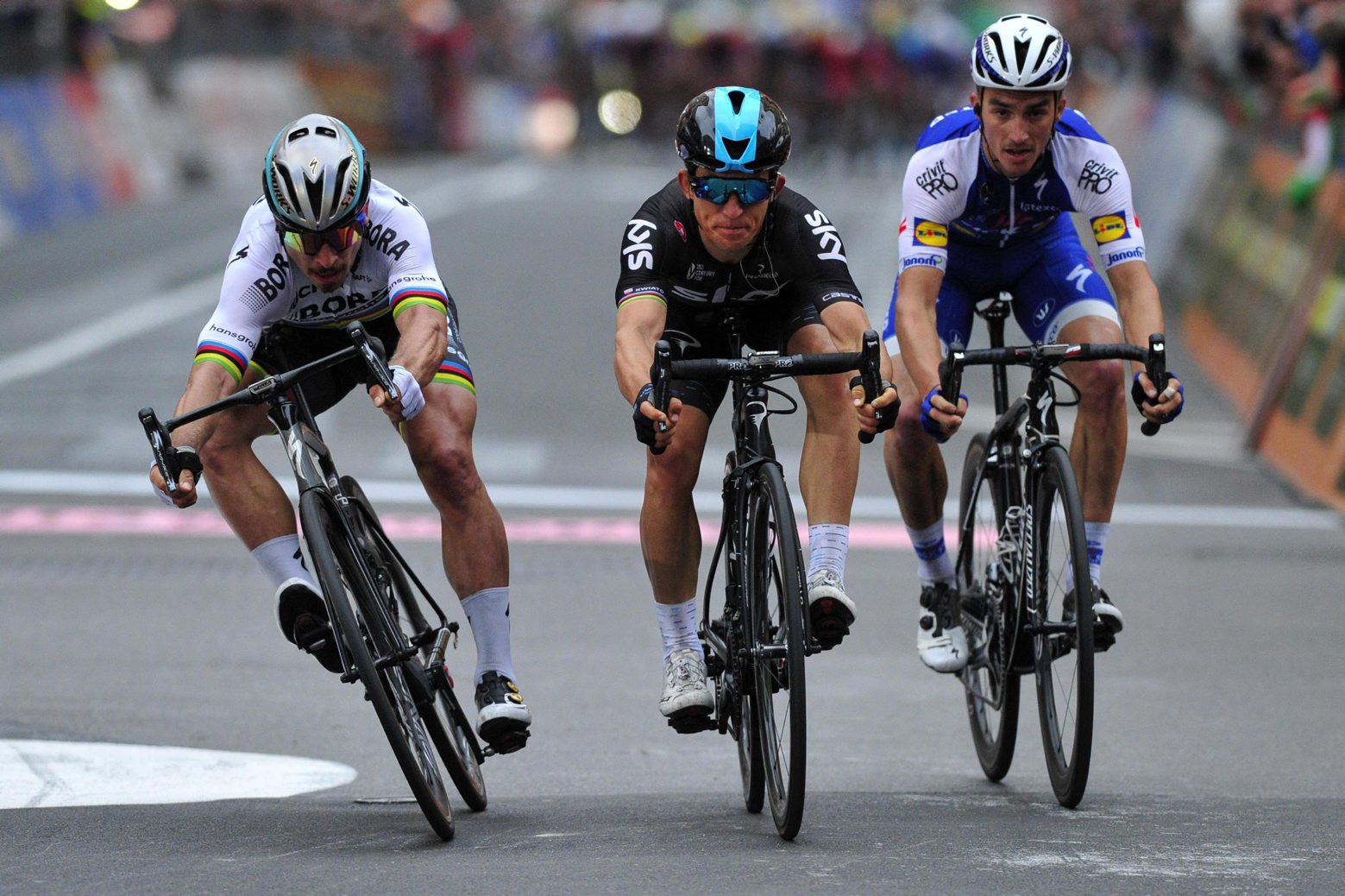 First placed Michal Kwiatkowski, center, crosses the finish line flanked by second placed Peter Sagan, left, and third placed Julian Alaphilippe at the 108th edition of the Milano-Sanremo cycling race from Milan to Sanremo,  in Milan, Italy, Saturday, March 18, 2017. (Dario Belingheri/ANSA via AP) Italy Milano Sanremo Cycling