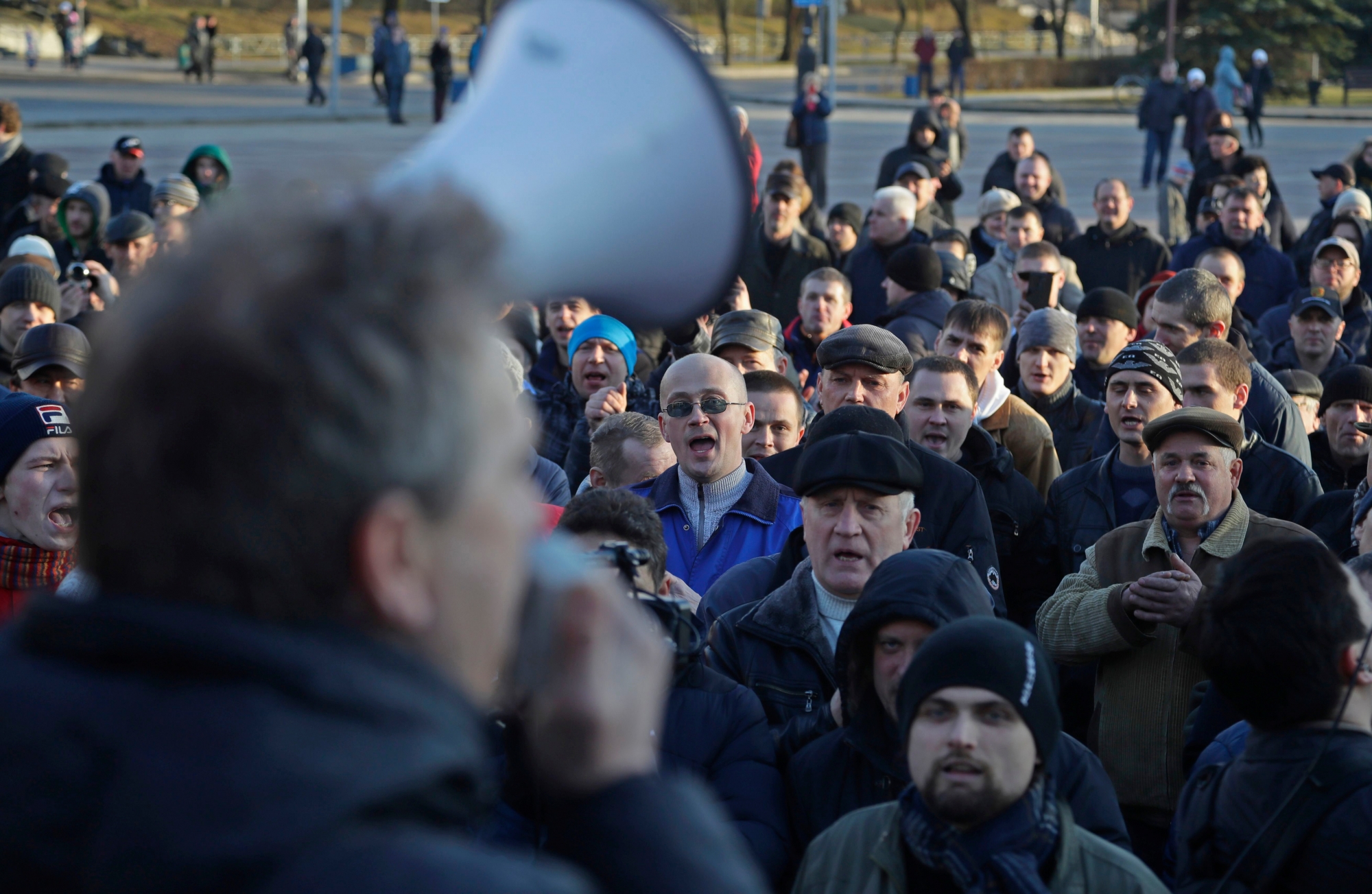 People shout slogans at a rally in the city of Maladzyechna, Belarus, Friday, March 10, 2017. The Friday demonstration came a day after President Alexander Lukashenko suspended the collection of fines from unemployed people. The two-year-old law, which imposes penalties of $250 on people who are jobless for more than six months but do no register on state labor exchanges, has been the focus of a wave of demonstrations over the past month. The protesters in Maladzyechna demanded the law be entirely annulled, and called for the end of Lukashenko's 23-year-long rule. (AP Photo/Sergei Grits) BELARUS PROTEST