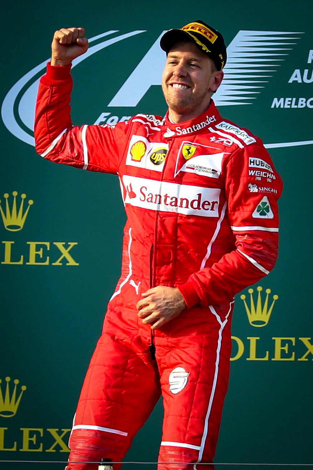 epa05871257 German Formula One driver Sebastian Vettel of Scuderia Ferrari celebrates on the podium after winning the 2017 Formula One Grand Prix of Australia at the Albert Park circuit in Melbourne, Australia, 26 March 2017.  EPA/DIEGO AZUBEL AUSTRALIA FORMULA ONE GRAND PRIX