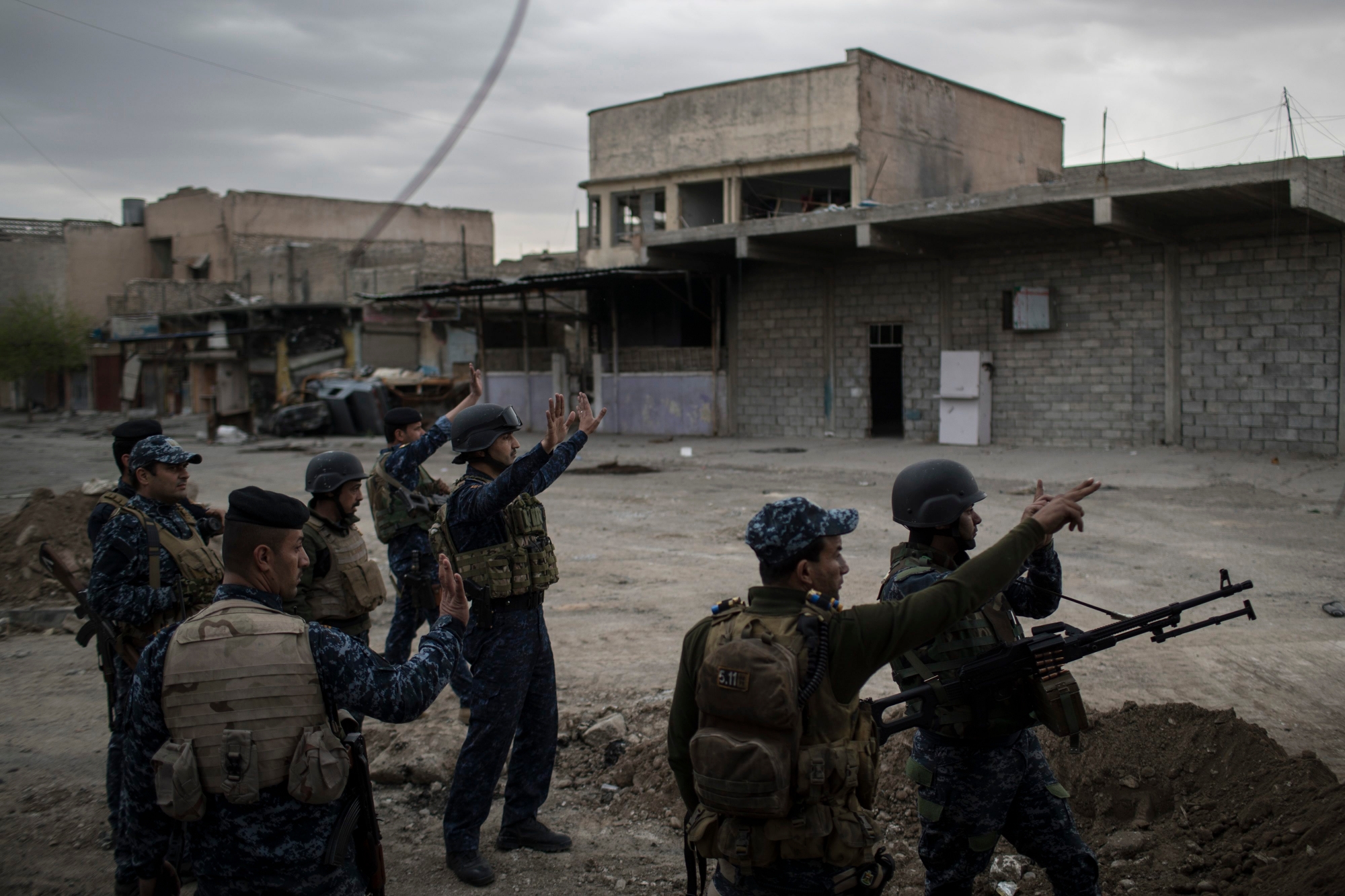 Federal Police soldiers gesture to other soldiers near the old city, during fighting against Islamic State militants on the western side of in Mosul, Iraq, Tuesday, March 28, 2017. (AP Photo/Felipe Dana) Iraq Mosul