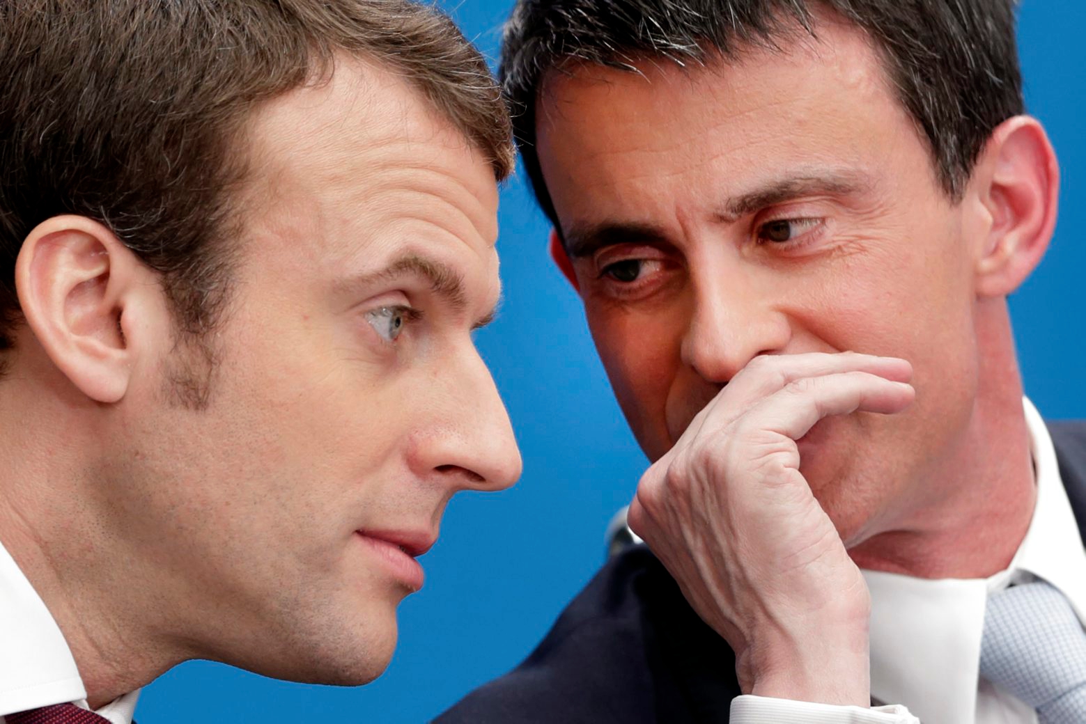 FILE - In this April 8, 2015 file photo, then French prime minister Manuel Valls, right, speaks with then economy minister Macron during in Paris. French centrist presidential hopeful Emmanuel Macron has won the backing of Socialist former prime minister Manuel Valls. (AP Photo/Philippe Wojazer/Pool, File) France Election