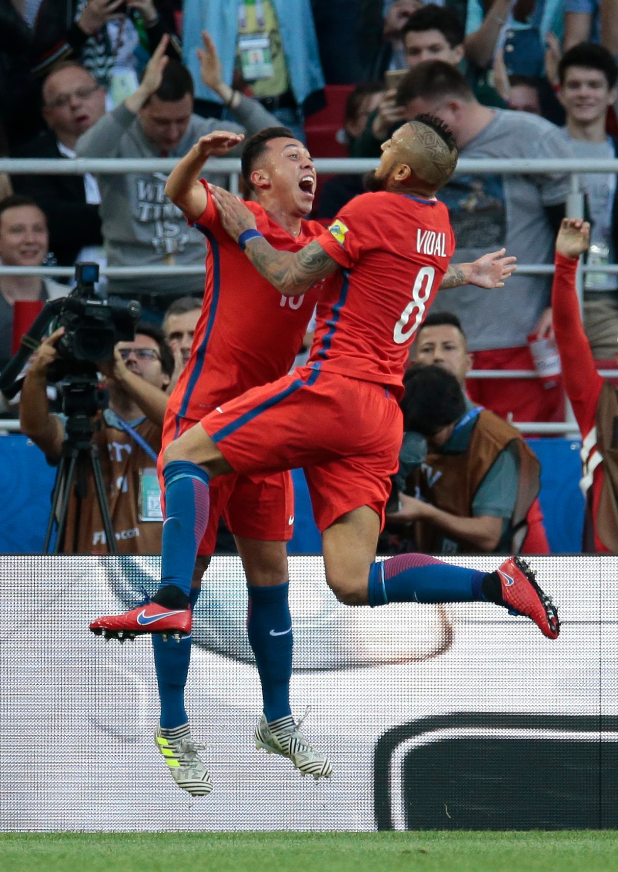 Chile's Martin Rodriguez, left, celebrates with Arturo Vidal after scoring his side's first goal during the Confederations Cup, Group B soccer match between Chile and Australia, at the Spartak Stadium in Moscow, Sunday, June 25, 2017. (AP Photo/Ivan Sekretarev) Soccer Confed Cup Chile Australia