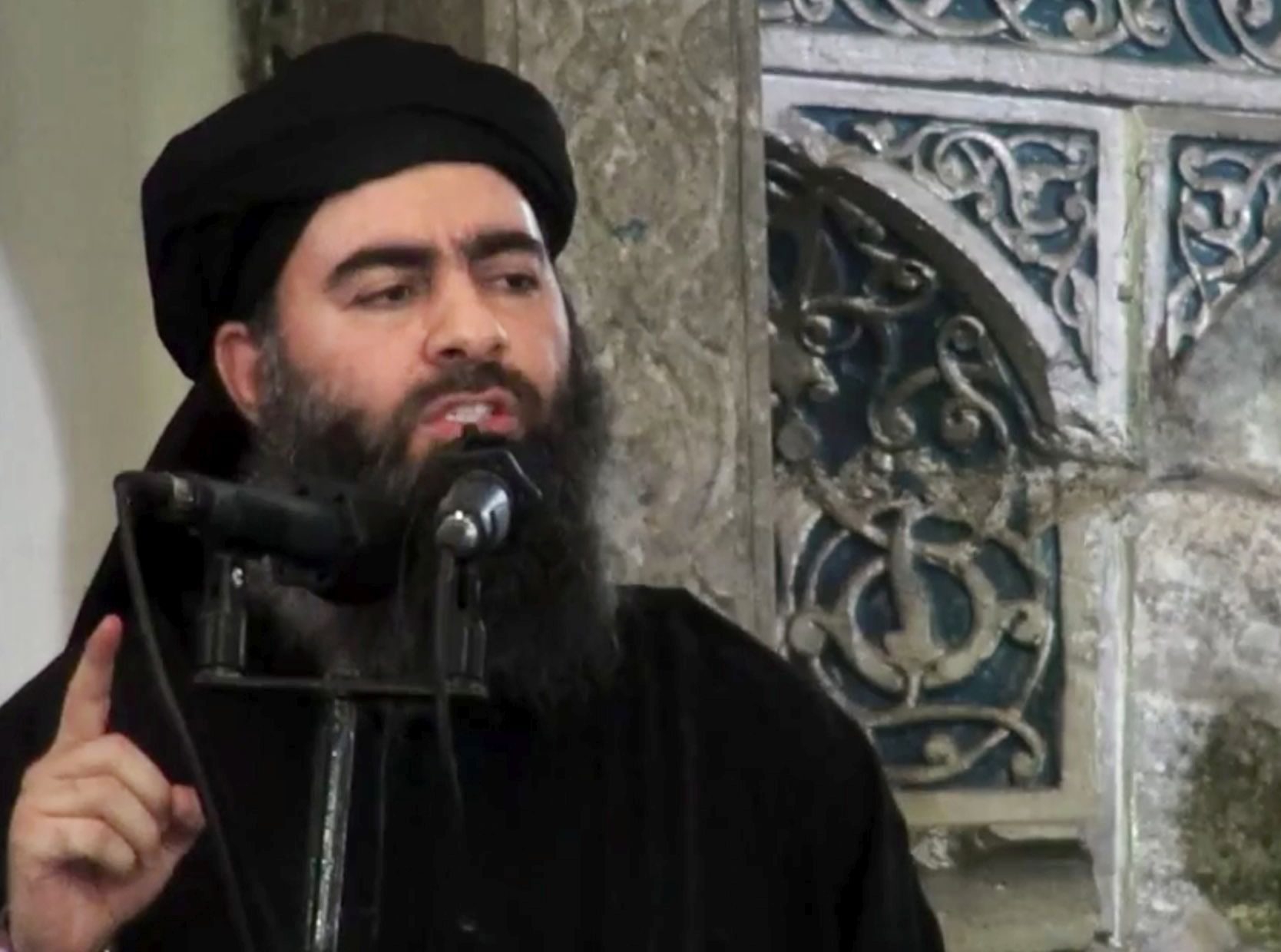 FILE - This file image made from video posted on a militant website July 5, 2014, purports to show the leader of the Islamic State group, Abu Bakr al-Baghdadi, delivering a sermon at a mosque in Iraq during his first public appearance. Islamic State group leader Abu Bakr al-Baghdadi appears to be still alive, a top U.S. military commander said Thursday, Aug. 31, 2017, contradicting RussiaÄôs claims that it probably killed the top counterterror target months ago.(Militant video via AP, File) UNITED STATES ISLAMIC STATE
