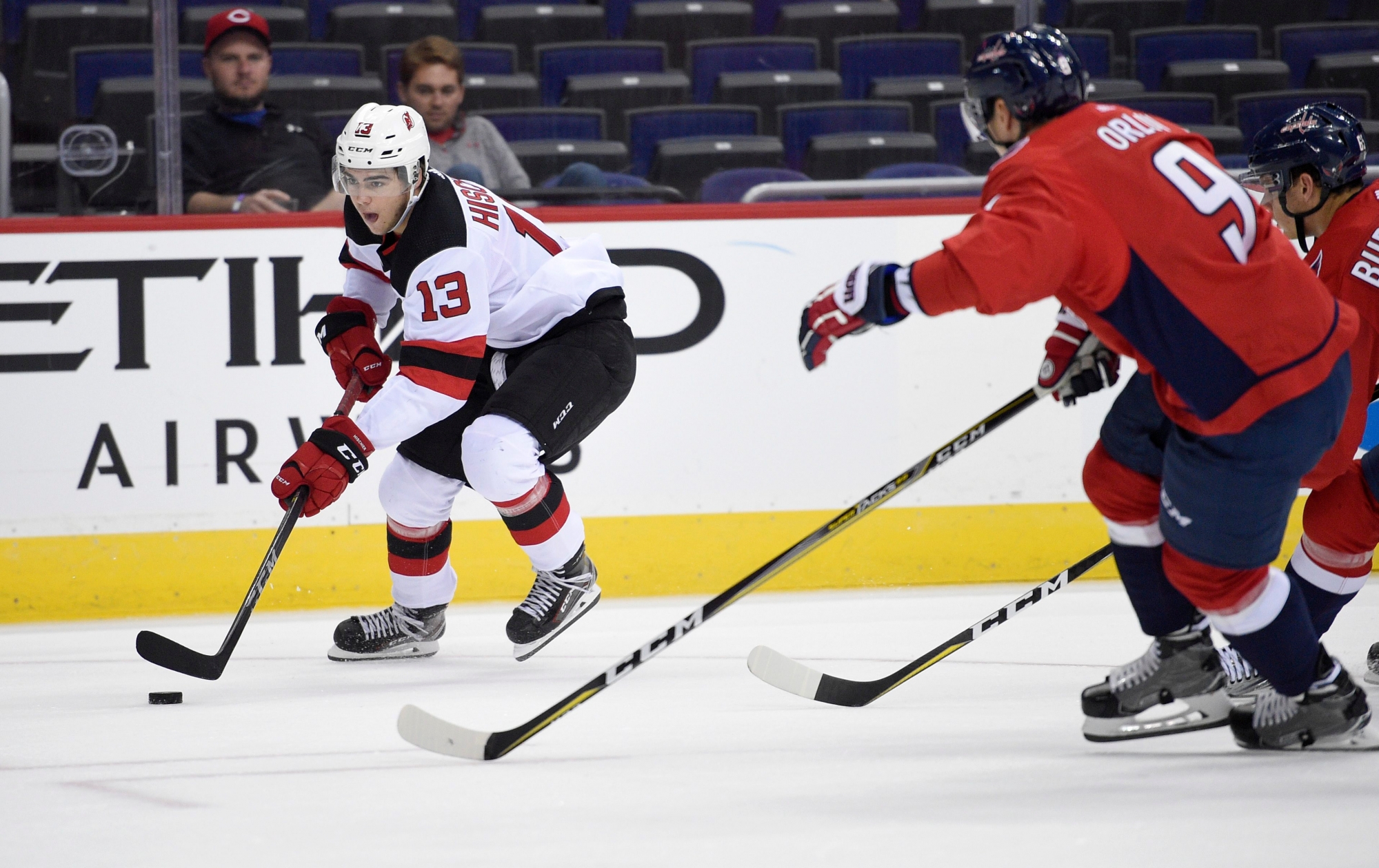 New Jersey Devils center Nico Hischier (13), of Switzerland, skates with the puck past Washington Capitals defenseman Dmitry Orlov (9), of Russia, during the first period of an NHL preseason hockey game, Wednesday, Sept. 27, 2017, in Washington. (AP Photo/Nick Wass) Devils Capitals Hockey