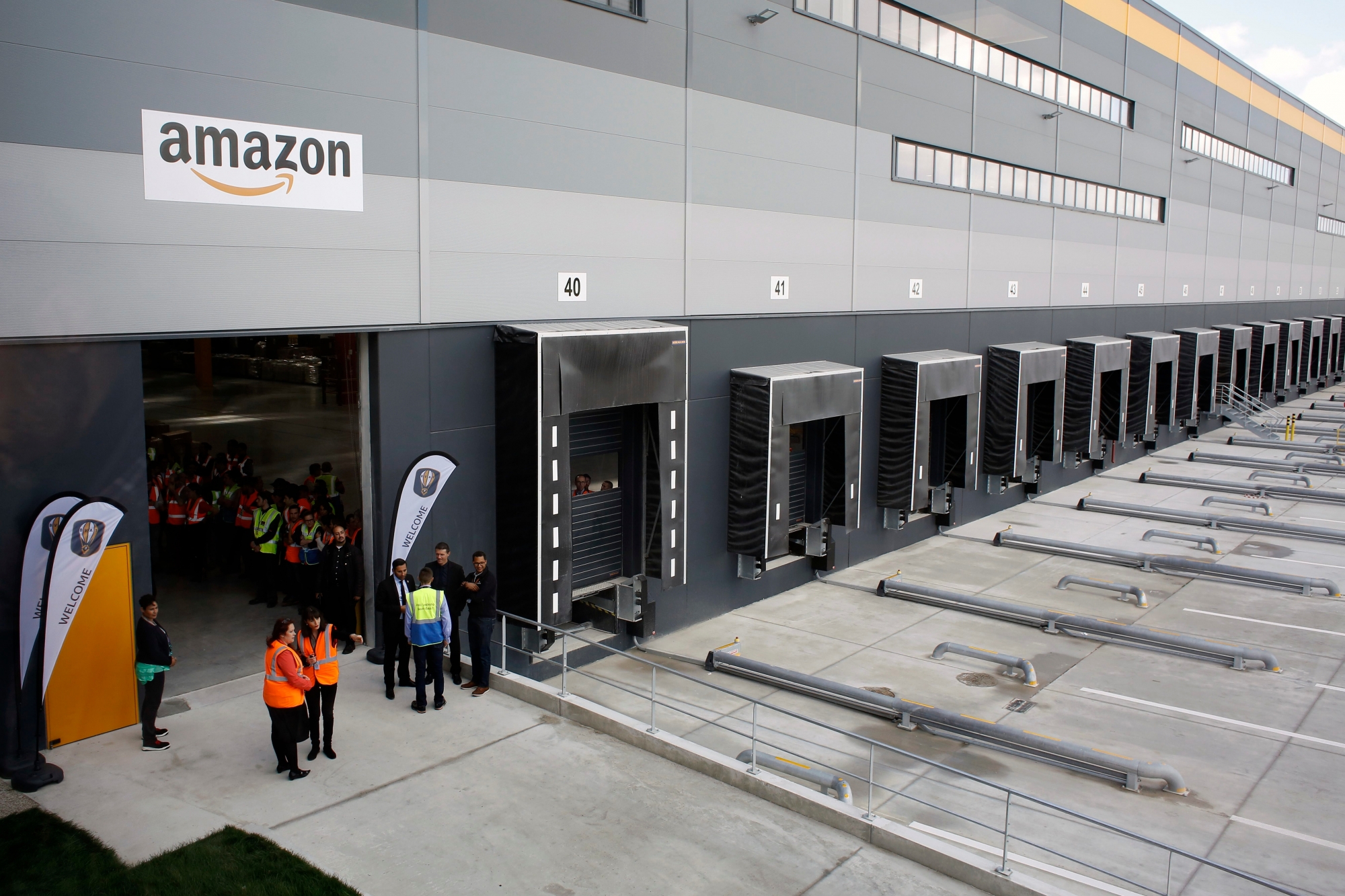 Employees wait for France's President Emmanuel Macron at new Amazon facility, in Longueau, northern France, Tuesday, Oct. 3, 2017. (AP Photo/Thibault Camus) France Macron Jobs