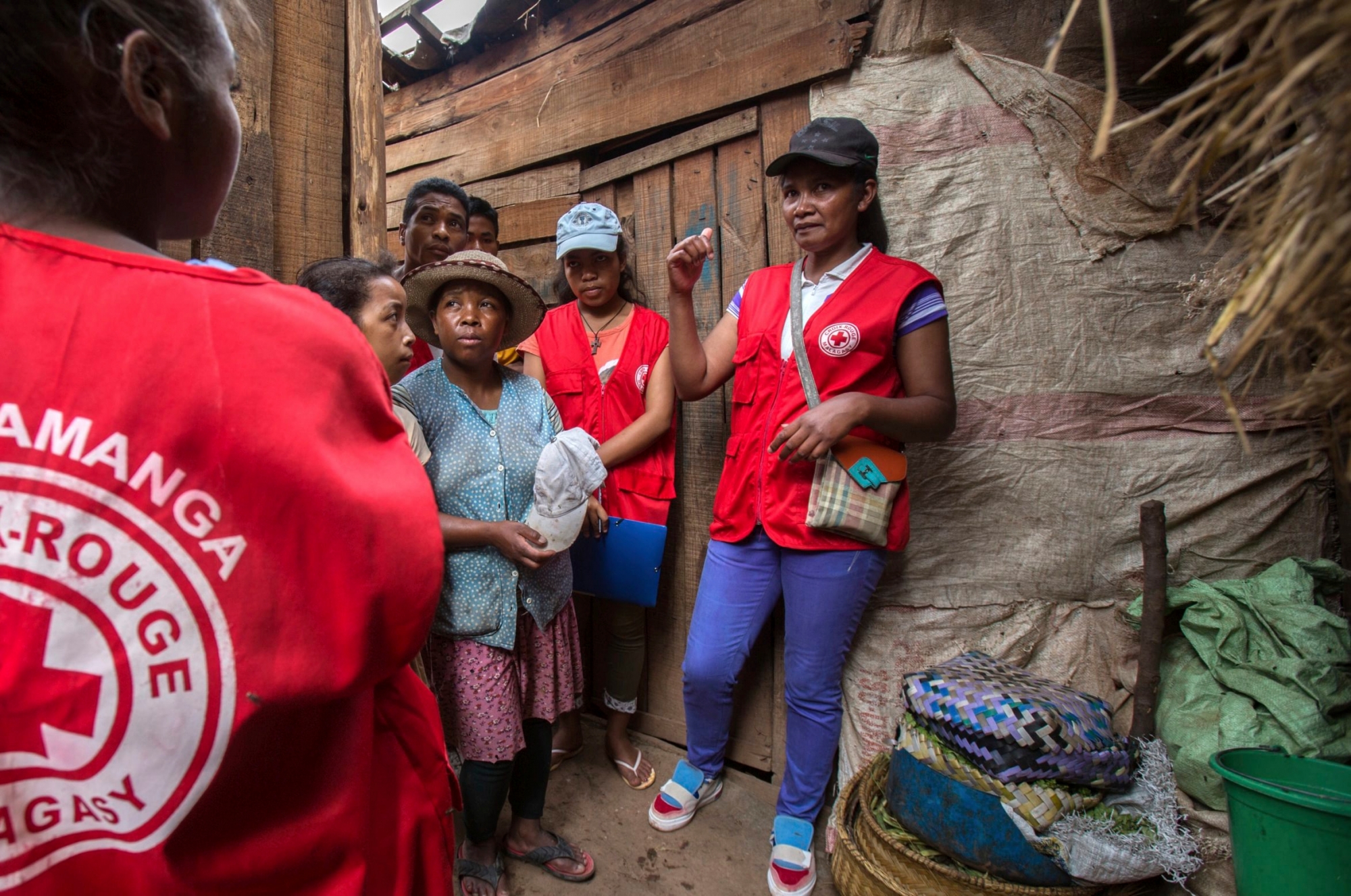 Red Cross volunteers talk to villagers about the plague outbreak, 30 miles west of Antananarivo, Madagascar, Monday, Oct. 16, 2017. As plague cases rose last week in Madagascar's capital, many city dwellers panicked. They waited in long lines for antibiotics at pharmacies and reached through bus windows to buy masks from street vendors. Schools have been canceled, and public gatherings are banned. (AP Photo/Alexander Joe) Madagascar Fighting Plague