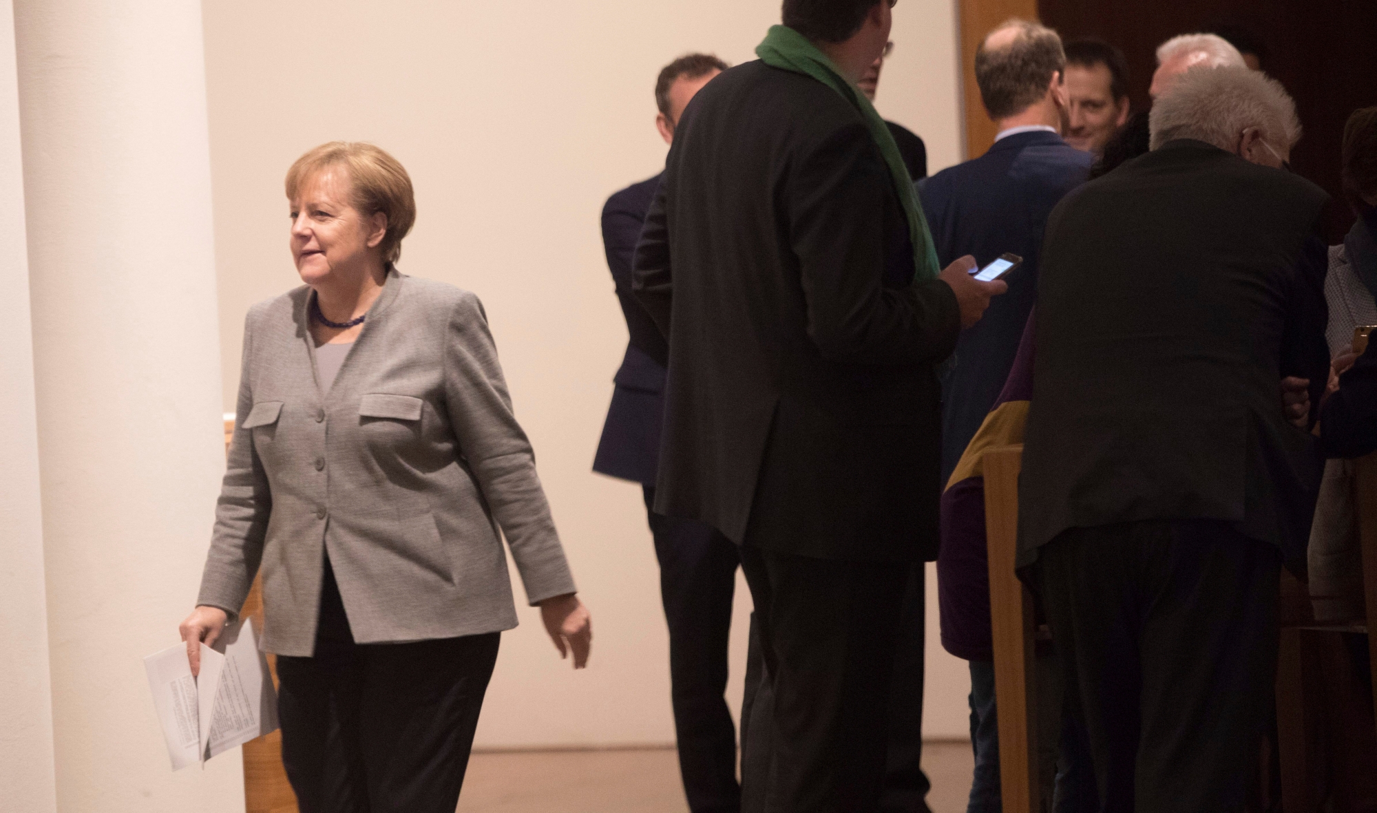 German chancellor Angela Merkel is on her way to another round of exploratory talks of her Christian parties' bloc , the Free Democrats and the Green Party, in Berlin, Sunday, Nov. 19, 2017. They are seeking compromises on the thorny issues of migration and climate change so they can proceed with formal talks on forming a new coalition government. ( Joerg Carstensen/dpa via AP) Germany Politics