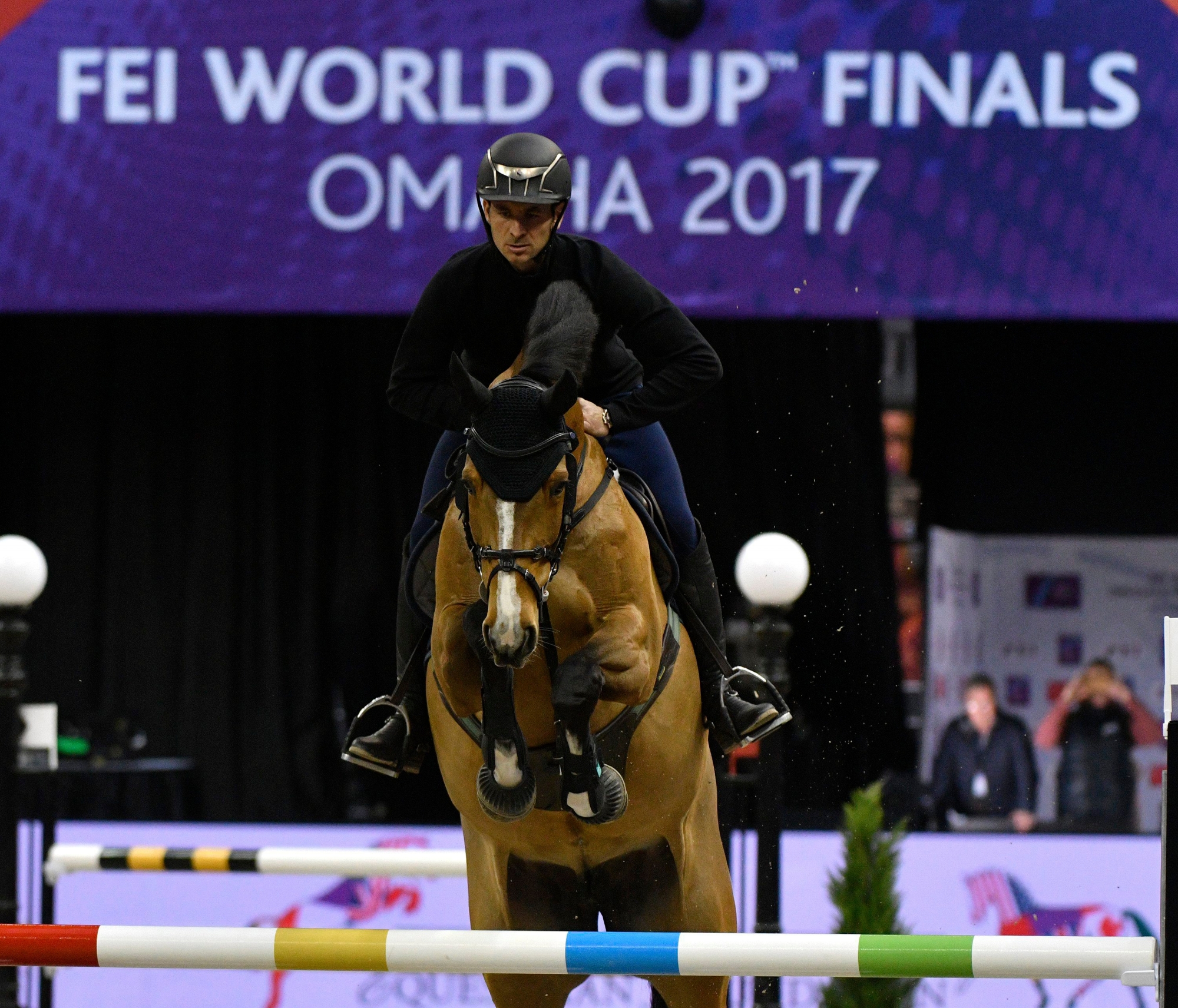 epa05878020 Swiss rider Steve Guerdat on horse Bianca  clears an obstacle as they participates in the jumping training session of the FEI World Cup Jumping and Dressage Finals held at CenturyLink Center in Omaha, Nebraska, USA, 29 March 2017.  EPA/ED ZURGA USA EQUESTRIAN FEI WORLD CUP FINALS