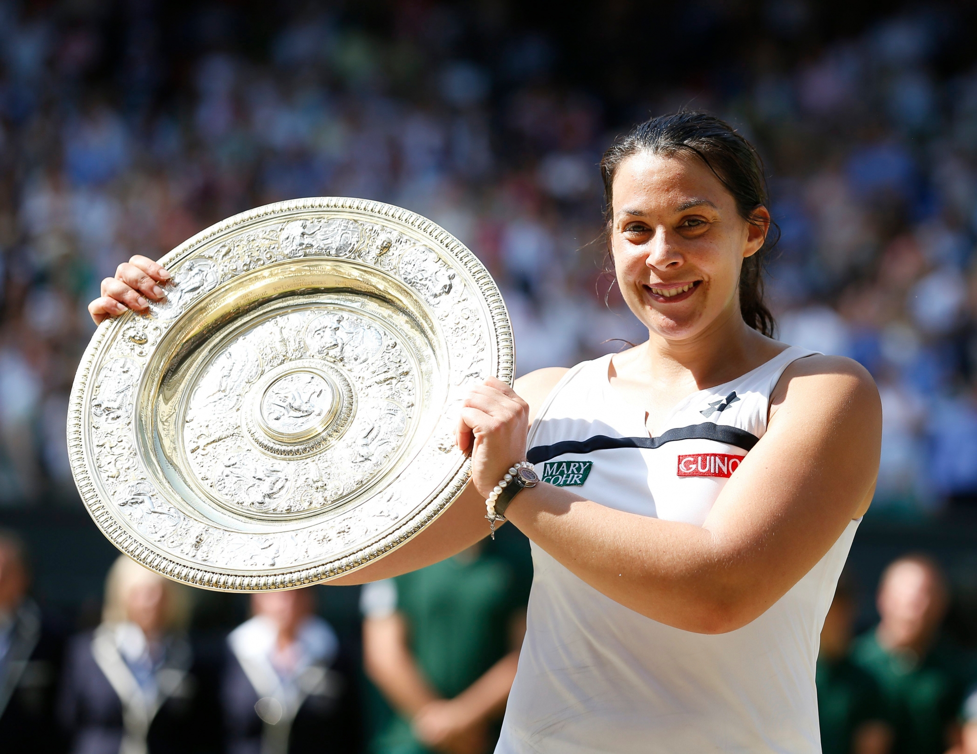 epa06399773 (FILES) Marion Bartoli of France hoists the championship trophy as she celebrates her victory over Sabine Lisicki of Germany in the women's final for the Wimbledon Championships at the All England Lawn Tennis Club, in London, Britain, 06 July 2013.  Bartoli, who retired from professional tennis shortly after winning the title, announced her return to the WTA Tour 20 December 2017.  EPA/KERIM OKTEN EDITORIAL USE ONLY/NO COMMERCIAL SALES FILES TENNIS MARION BARTOLI