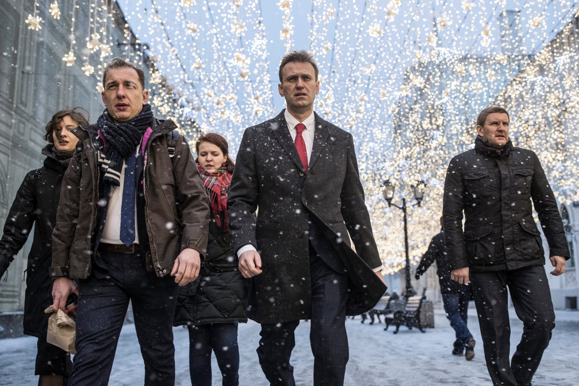 Russian opposition leader Alexei Navalny, who submitted endorsement papers necessary for his registration as a presidential candidate, center, heads to attend a meeting in the Russia's Central Election commission in Moscow, Russia, Monday, Dec. 25, 2017. Russian election officials have formally barred Russian opposition leader Alexei Navalny from running for president. (Evgeny Feldman/Navalny Campaign via AP) APTOPIX Russia Election