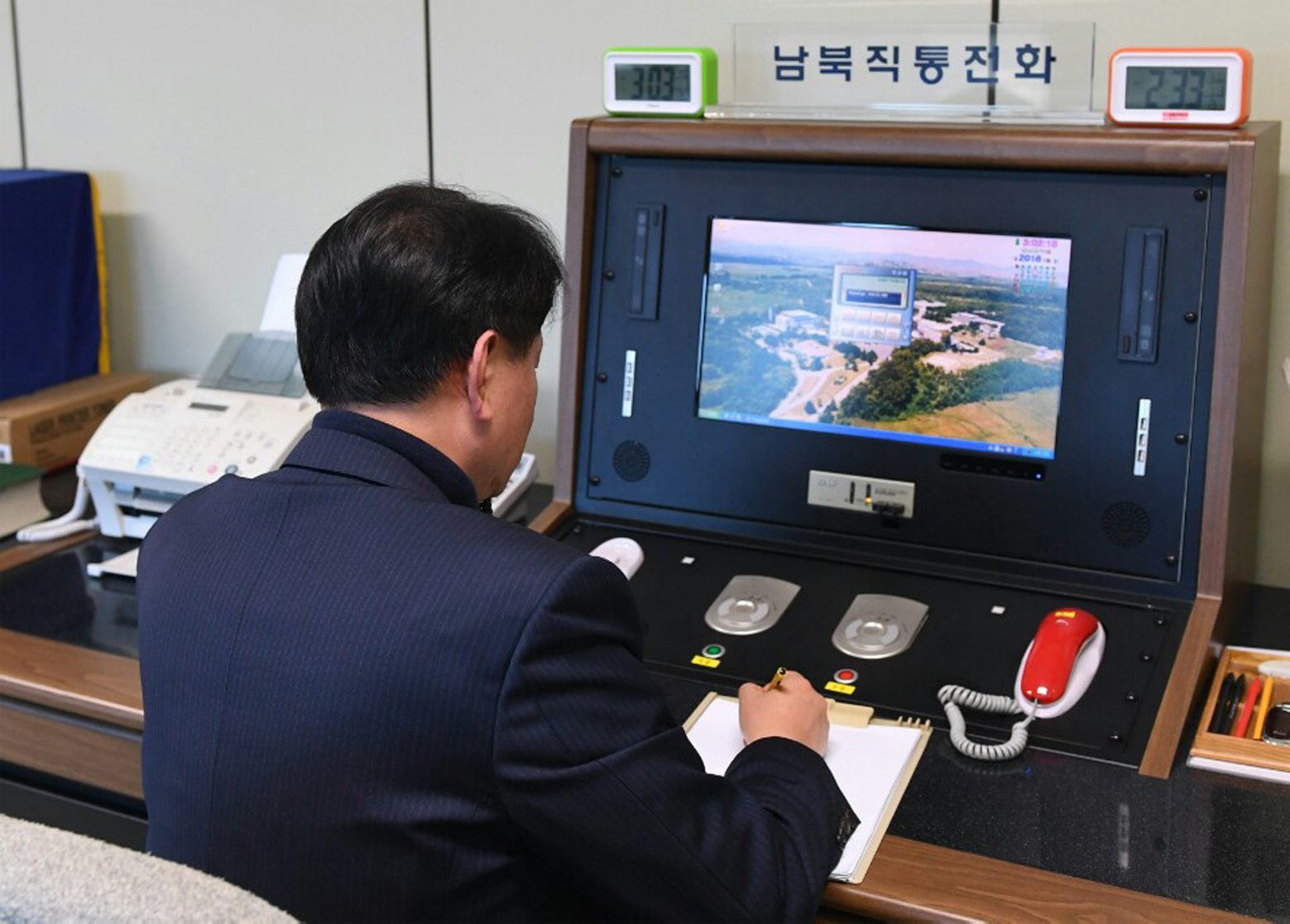 A South Korean government official checks the direct communications hotline to talk with the North Korean side at the border village of Panmunjom in Paju, South Korea, Wednesday, Jan. 3, 2018. North Korean leader Kim Jong Un reopened a key cross-border communication channel with South Korea on Wednesday, another sign easing animosity between the rivals even as Kim traded combative threats of nuclear war with President Donald Trump. (Yonhap via AP) South Korea Koreas Tensions