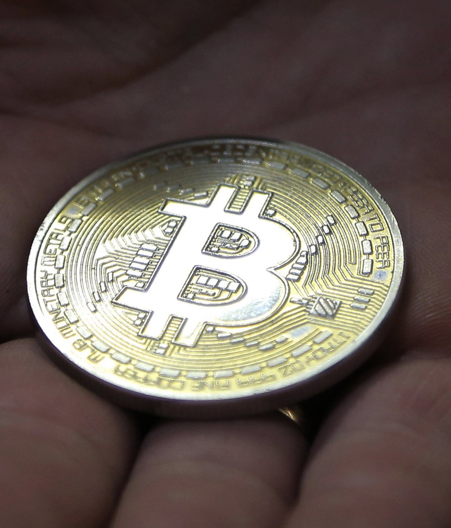 epa06375828 (FILE) - A visitor holds a Bitcoin (virtual currency) souvenir coin, during a webinar by Russian businessman, Orthodox activist and founder the Crypto exchange CryptoSterlingClub Alisa, German Sterligov at the main office of CryptoSterlingClub Alisa in Moscow, Russia, 29 August 2017. Media reports on 08 December 2017 state that the value of teh Bitcoin currency peaked over 17,000 US dollars in trading in Asia.  EPA/MAXIM SHIPENKOV (FILE) RUSSIA BITCOIN TRADING