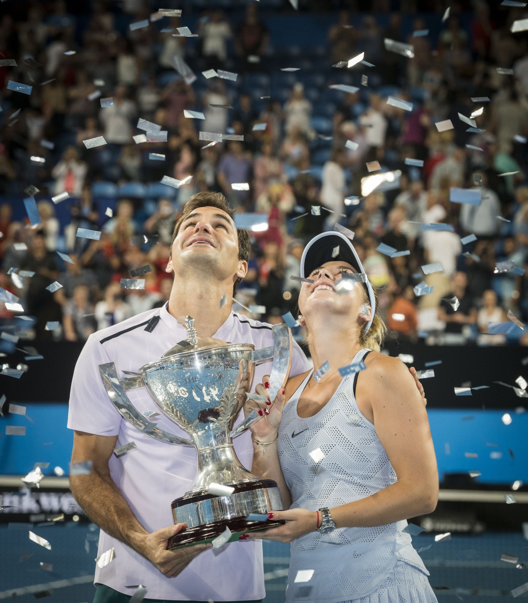 epa06420711 Roger Federer and Belinda Bencic of Switzerland celebrate their finals win with the Hopman Cup after winning on the final day of the Hopman Cup final between Switzerland and Germany at the Perth Arena in Perth, Australia, 06 January 2018.  EPA/TONY MCDONOUGH AUSTRALIA AND NEW ZEALAND OUT  EDITORIAL USE ONLY  EDITORIAL USE ONLY  EDITORIAL USE ONLY  EDITORIAL USE ONLY  EDITORIAL USE ONLY AUSTRALIA TENNIS HOPMAN CUP