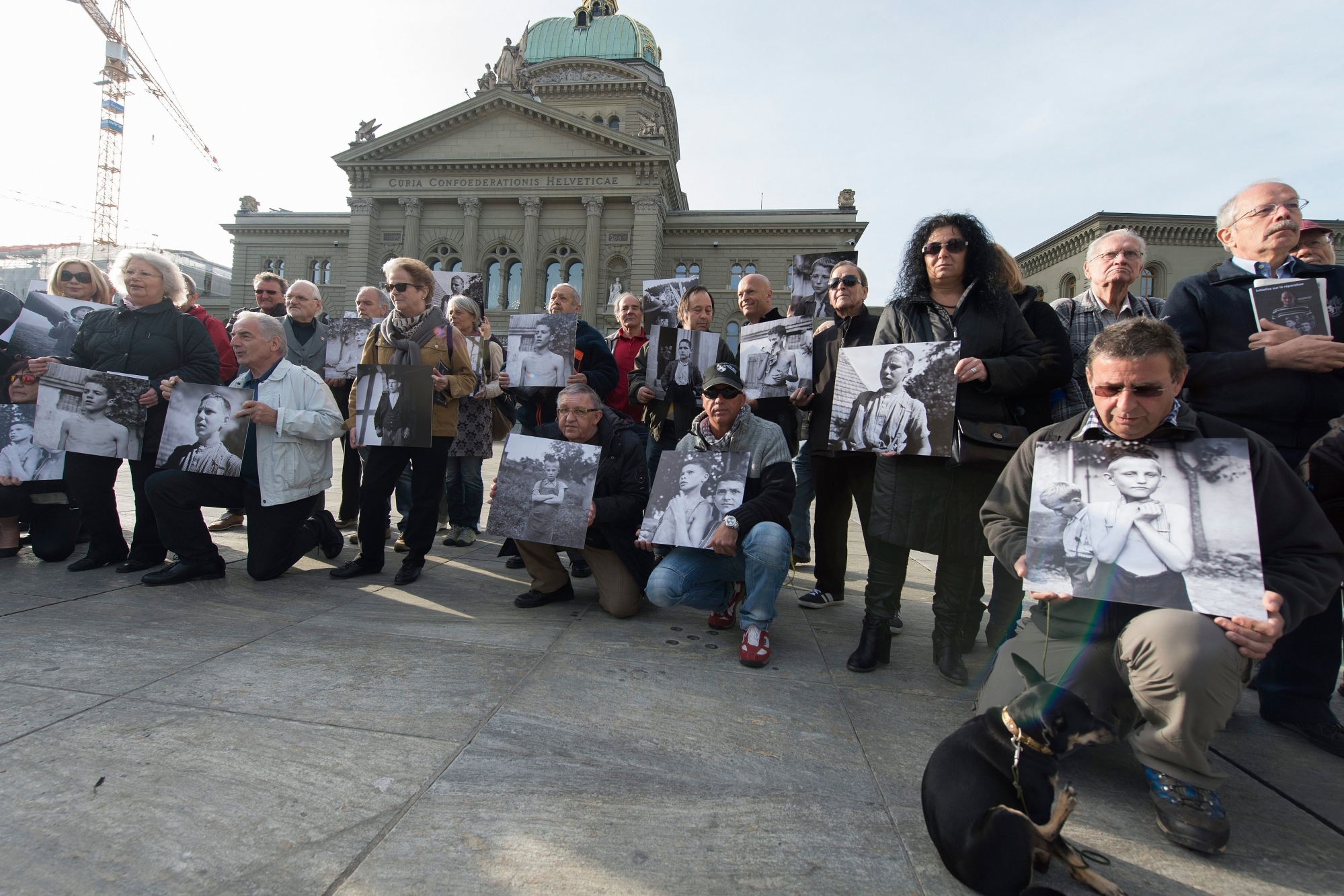 Ehemalige Verdingkinder und Opfer von fuersorgerischen Massnahmen posieren mit Kinderfotos vor dem Bundeshaus am Montag, 31. Maerz 2014, in Bern. Opfer administrativer Zwangsmassnahmen werden per Gesetz rehabilitiert. Einem ueberparteilichen Komitee genuegt dies nicht: Am Montag hat die Gruppe eine Initiative lanciert mit dem Ziel, einen Entschaedigungs-Fonds ueber 500 Millionen Franken einzurichten. Rund 20'000 Menschen sind im letzten Jahrhundert in der Schweiz Opfer fuersorgerischer Zwangsmassnahmen geworden. (KEYSTONE/Lukas Lehmann) SCHWEIZ VERDINGKINDER WIEDERGUTMACHUNG OPFER BUNDESHAUS KOMITEE