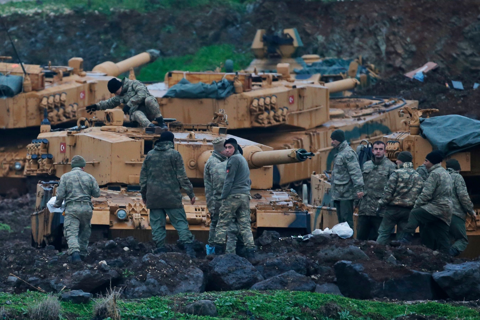 Turkish soldiers prepare their tanks to enter combat and join a military offensive on a Kurdish-held enclave in northern Syria, at a staging area in the Hatay province,Turkey near the the border with Syria.Turkey launched an operation, codenamed Olive Branch, last week against the Syrian Kurdish People's Protection Units in Afrin, Syria that it deems a terror group. The operation codenamed Olive Branch is on its fourth day. (AP Photo/Lefteris Pitarakis) Turkey Syria