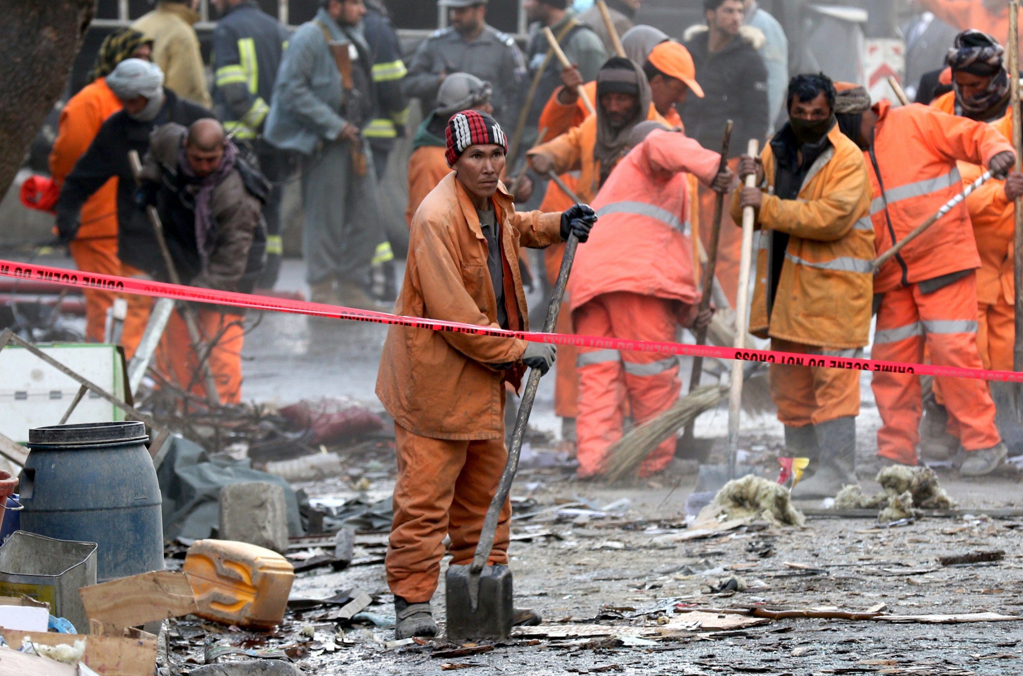 epa06479065 Afghan muncipality workers at the scene of a suicide bomb attack in Kabul, Afghanistan, 27 January 2018. Death toll climbed to 95 while 158 were injured in the massive Taliban car-bomb attack in Sadarat Square, downtown Kabul, according to Afghan Ministry of Health. The Taliban resorted to an ambulance loaded with explosives to carry out the attack in a busy commercial area near the former Interior Ministry building and a facility of the National Directorate of Security (NDS).  EPA/HEDAYATULLAH AMID AFGHANISTAN BOMB EXPLOSION
