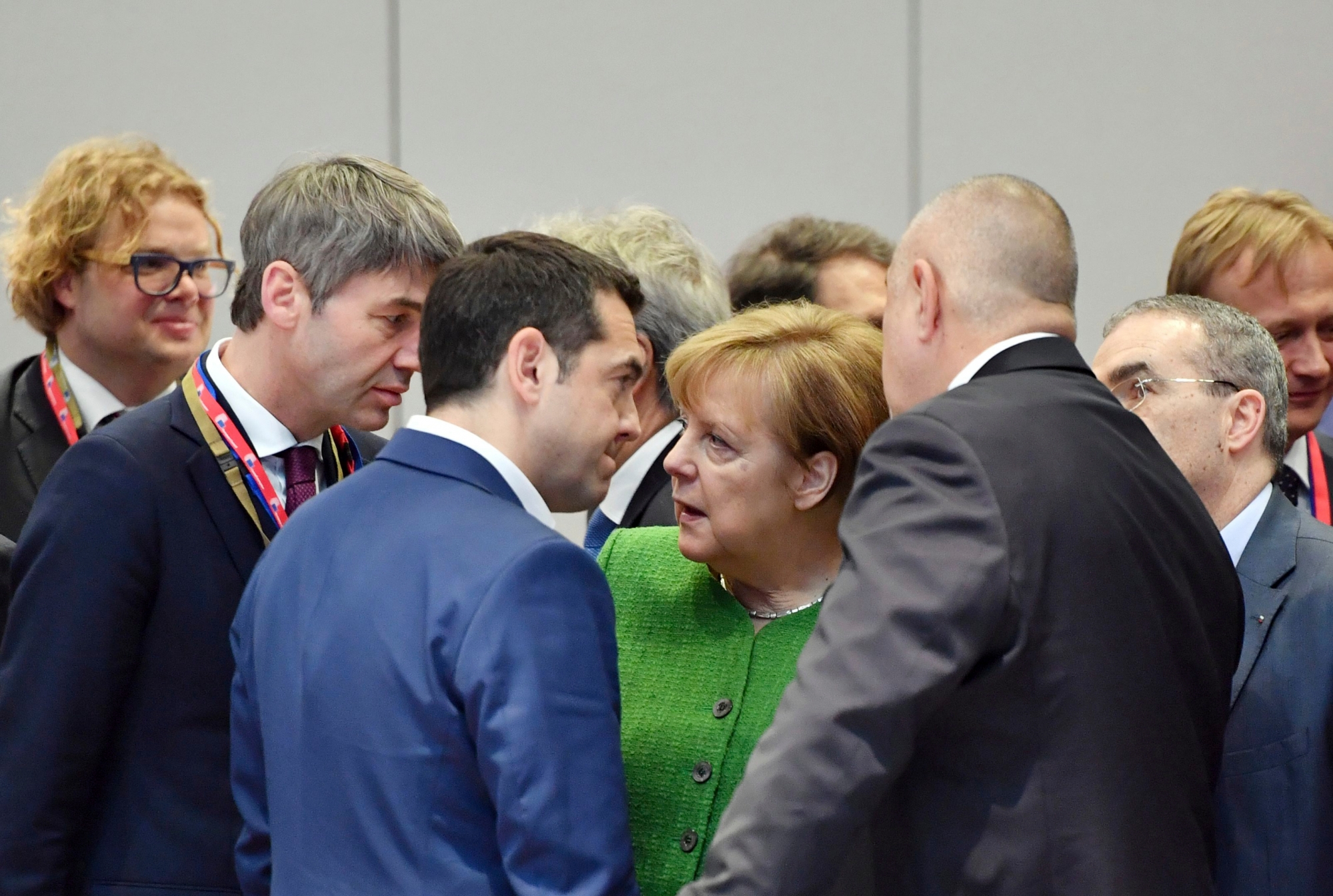 German Chancellor Angela Merkel, center, speaks with Greek Prime Minister Alexis Tsipras, center left, and Bulgarian Prime Minister Boyko Borissov, center right, during a round table at an EU summit at the Europa building in Brussels on Friday, Feb. 23, 2018. European Union leaders meet without Britain Friday looking to plug a major budget hole after Brexit and endorse a plan to streamline the European Parliament by sharing out the country's seats. (AP Photo/Geert Vanden Wijngaert) Belgium Europe Summit