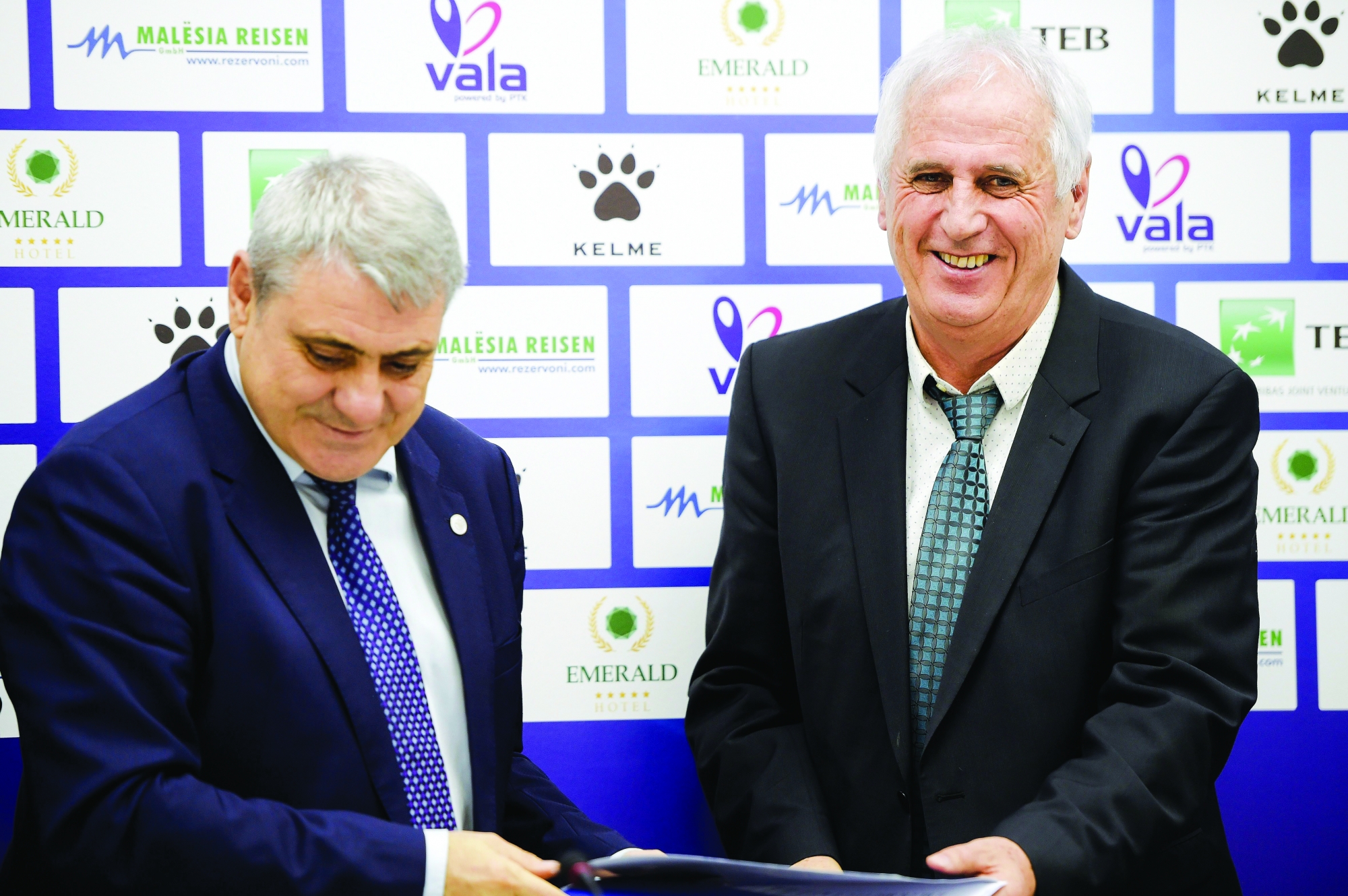 Newly appointed head coach of Kosovo national soccer team Bernard Challandes, right, smiles after signing a contract with president of the Kosovo soccer Federation Fadil Vokrri, during a press conference, in Pristina, Kosovo, Friday, March 2, 2018. The Kosovo soccer federation has appointed Challandes as coach of the national team. The 66-year-old Swiss coach signed a two-year contract.  (AP Photo/Visar Kryeziu) Kosovo New Coach