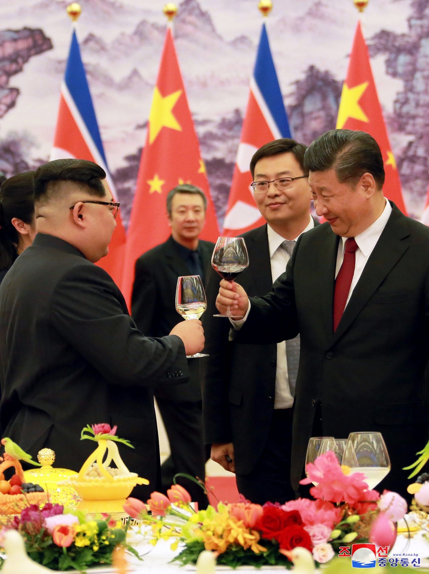 In this March 26, 2018, photo, North Korean leader Kim Jong Un, left, and Chinese counterpart Xi Jinping hold a glass for a toast during a banquet at the Great Hall of the People in Beijing. North Korea's leader Kim and his Chinese counterpart Xi sought to portray strong ties between the long-time allies despite a recent chill as both countries on Wednesday, March 28, 2018, confirmed Kim's secret trip to Beijing this week. The content of this image is as provided and cannot be independently verified. Korean language watermark on image as provided by source reads: "KCNA" which is the abbreviation for Korean Central News Agency.  (Korean Central News Agency/Korea News Service via AP) China North Korea
