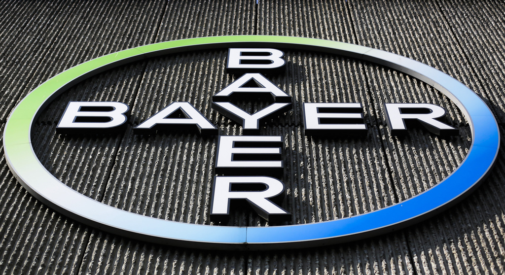 FILE - This Monday, May 23, 2016, file photo, shows the Bayer AG corporate logo displayed on a building of the German drug and chemicals company in Berlin.  The German pharmaceutical giant has agreed, Tuesday, May 29, 2018,  to the U.S. government's demand that it sell about $9 billion in agriculture businesses as condition for acquiring Monsanto Co., a U.S. seed and weed-killer maker. Antitrust regulators at the Justice Department say it's the biggest divestiture ever required for a merger.  (AP Photo/Markus Schreiber, File)