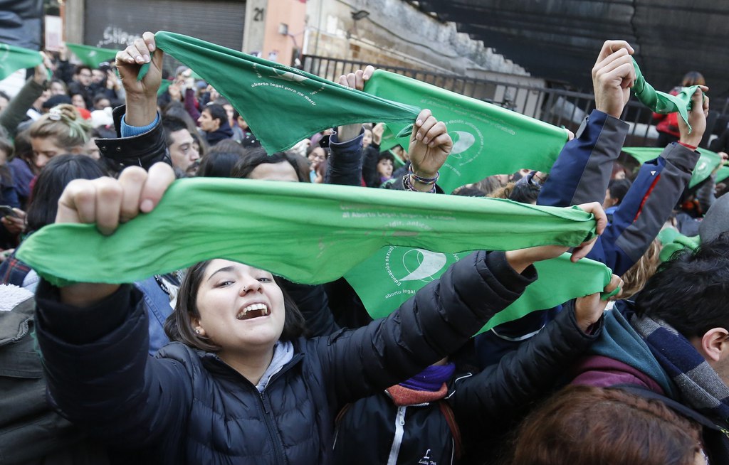 Foulards verts brandis à bout de bras, ces manifestants célèbrent l'approbation du projet de loi légalisant l'avortement par la chambre basse du congrès, devant le Parlement, à Buenos Aires.