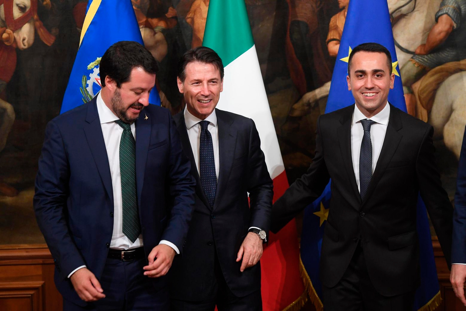 Italian Prime Minister Giuseppe Conte, center, poses with his vice Prime Ministers Luigi Di Maio, right, and Matteo Salvini, after receiving from the outgoing Prime Minister Paolo Gentiloni the small silver bell used to open the First Council of Minister at Chigi Palace in Rome, Friday, June 1, 2018. (Claudio Peri/ANSA via AP) Italy Politics