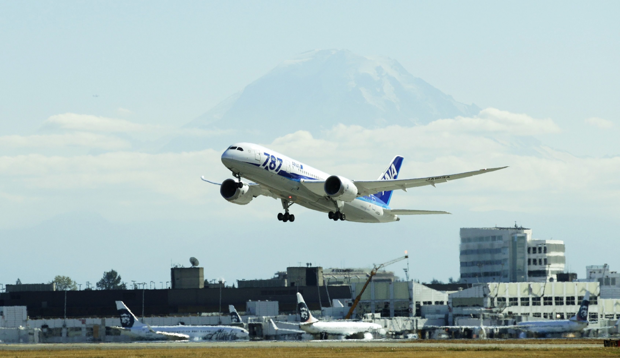 With Mount Rainier in the background, the first scheduled Boeing 787 airplane to depart from Seattle-Tacoma International Airport takes off  Tuesday, Oct. 2, 2012 in Seattle. The plane, operated by All Nippon Airways, will serve ANA's Seattle-Tokyo route. (AP Photo/Ted S. Warren) Seattle Tokyo Dreamliner