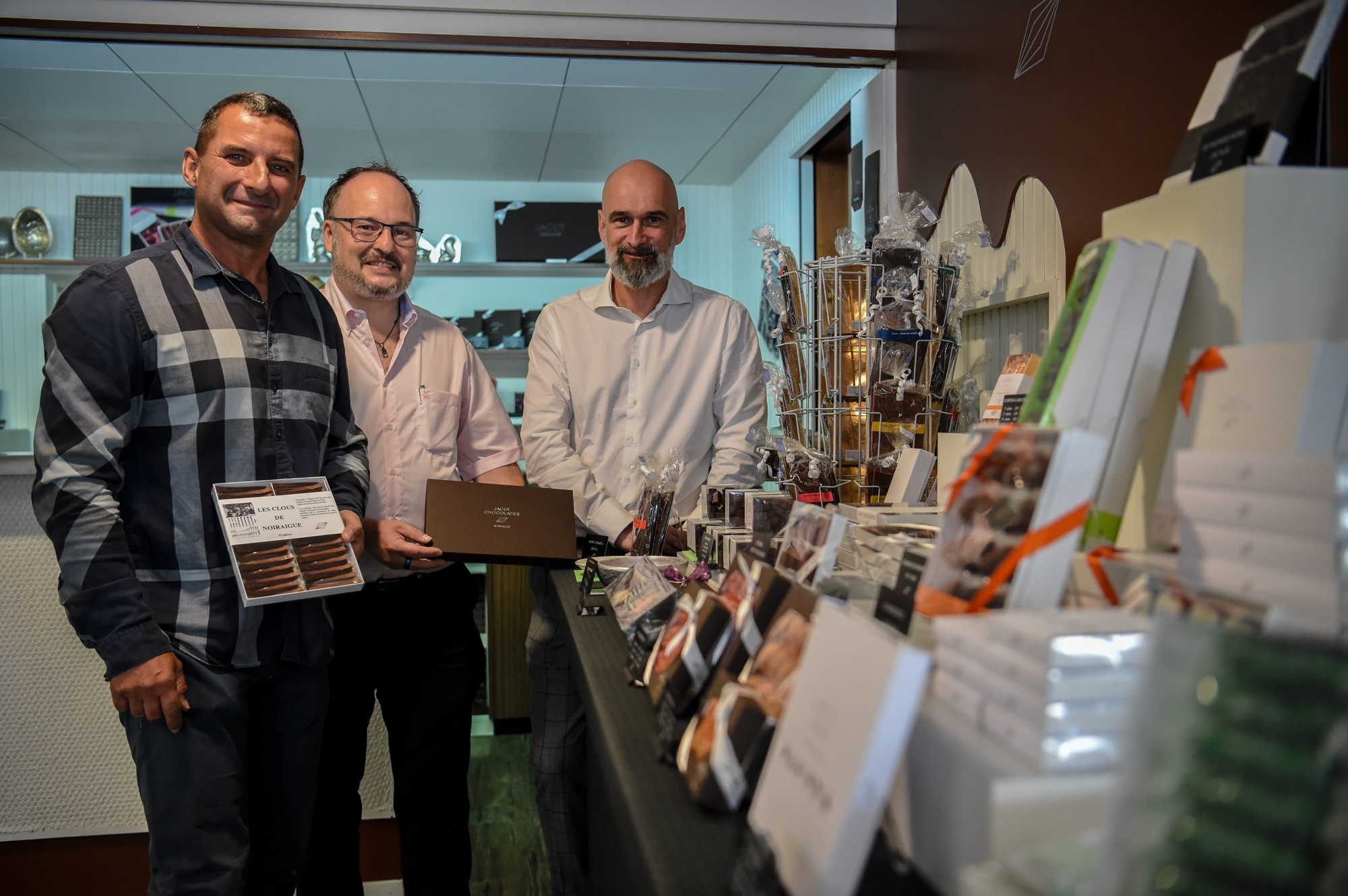 Jacot Chocolatier. Le nouveau boss, Daniel Knoepfel (à droite) et les deux co-investisseurs, Andreas Schalch (à gauche) et Nicolas Joye dans la boutique  de la maison-mère, à Noiraigue.