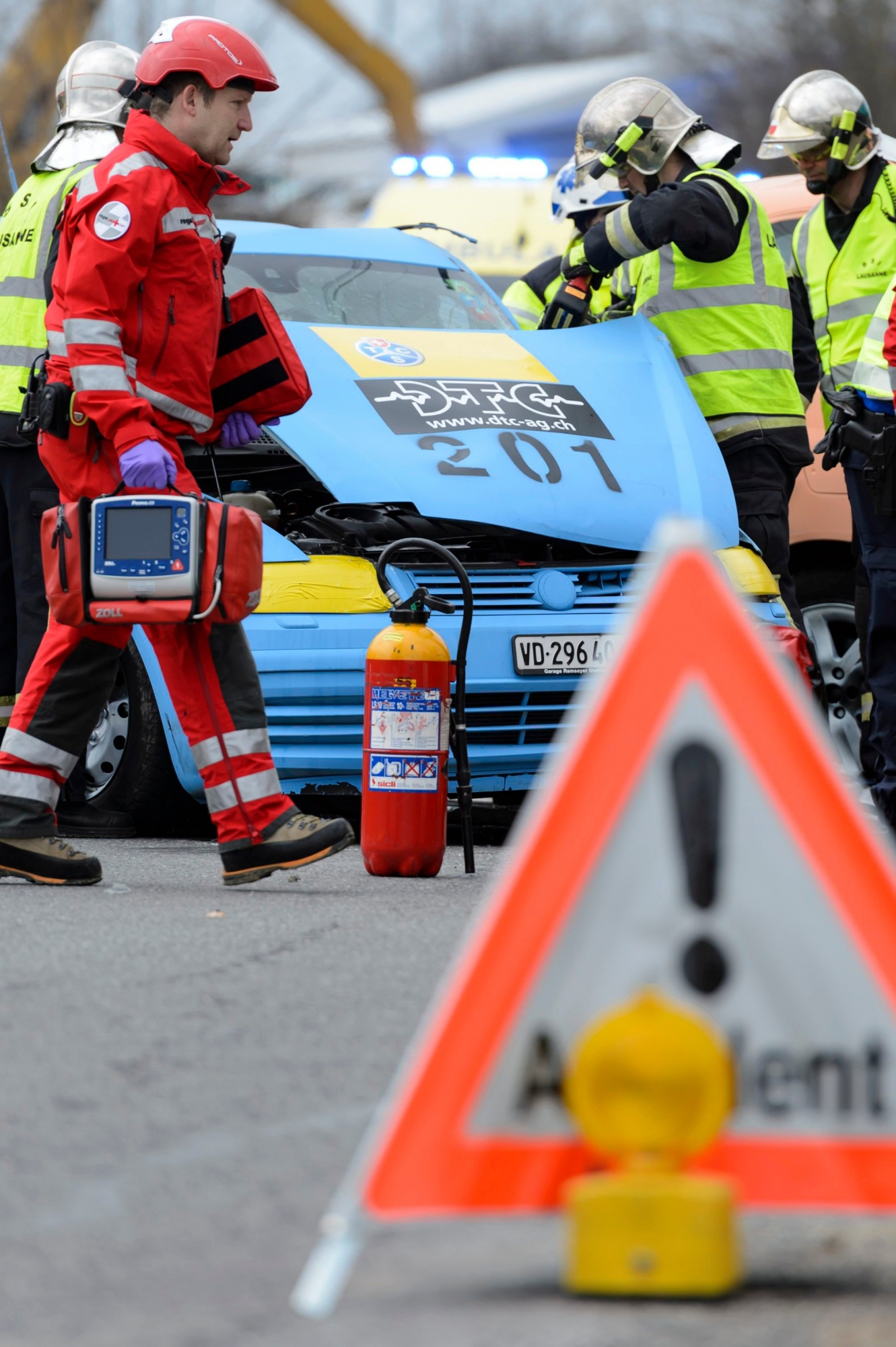 Des secouristes, policiers, ambulanciers, pompiers, rega, effectuent les premiers secours sur des blesses fictifs lors d'un crash test "la bonne conduite" simulant un accident entre deux voiture, ce mercredi, 25 mars 2015, au Mont-sur-Lausanne. Dans le cadre de la campagne de prevention routiere "la bonne conduite", et pour la premiere fois en Suisse, la Police cantonale vaudoise, le Touring Club Suisse (TCS), le Service des automobiles et de la navigation, le Service mobile d'urgence et de reanimation, la Direction generale de la mobilite et des routes, la Rega, ainsi que le Service de Protection et Sauvetage Lausanne, simulent un accident entre deux voitures en situation reel. Le but de la demonstration est d'estimer les couts reels, directs et indirects, díun accident de circulation. (KEYSTONE/Laurent Gillieron) SCHWEIZ VERKEHR SICHERHEIT CRASHTEST