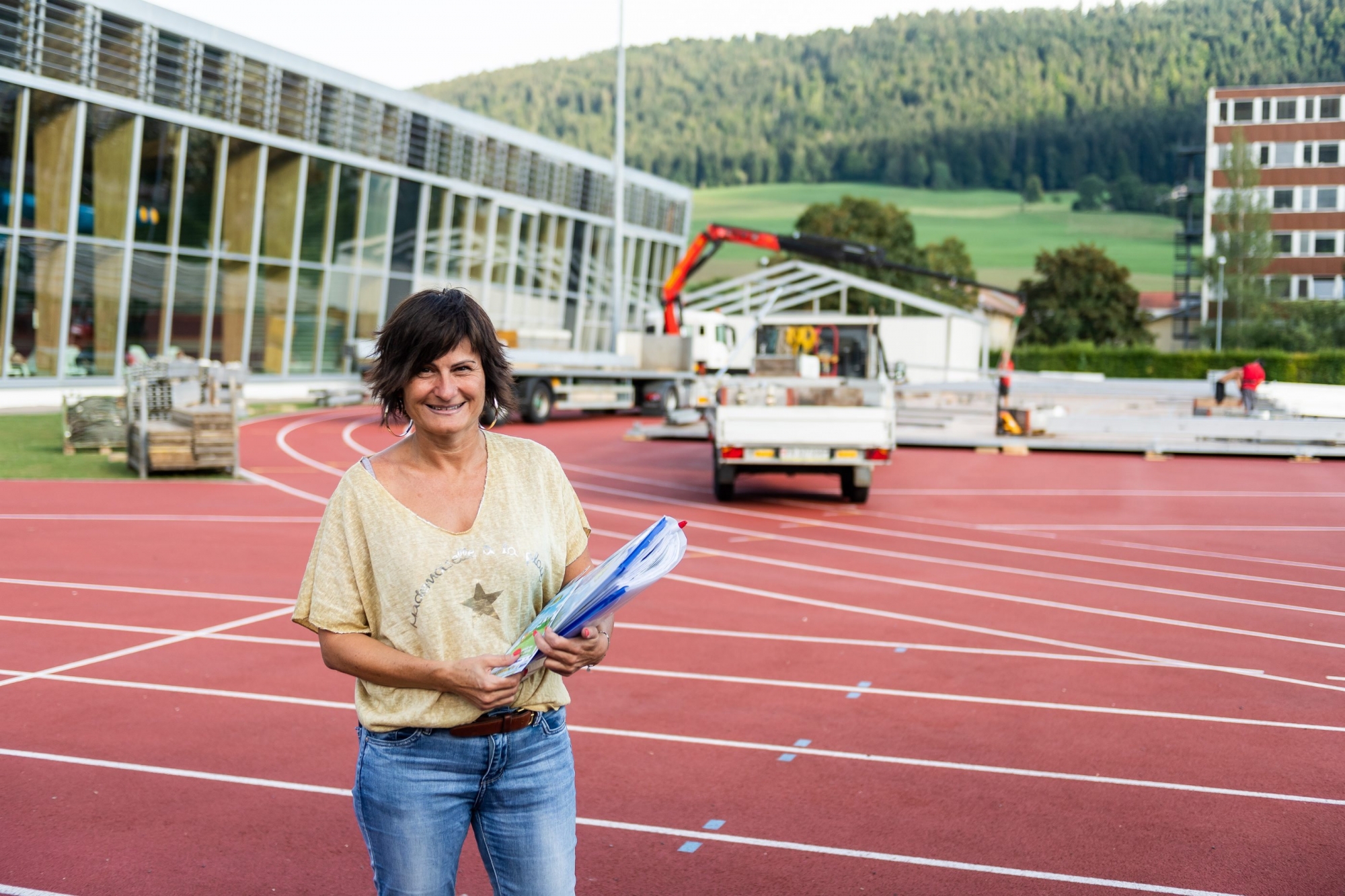 Le présidente du comptoir Sandra Eggenschwiler devant les tentes en train d'être dressées au Centre sportif régional de Couvet.