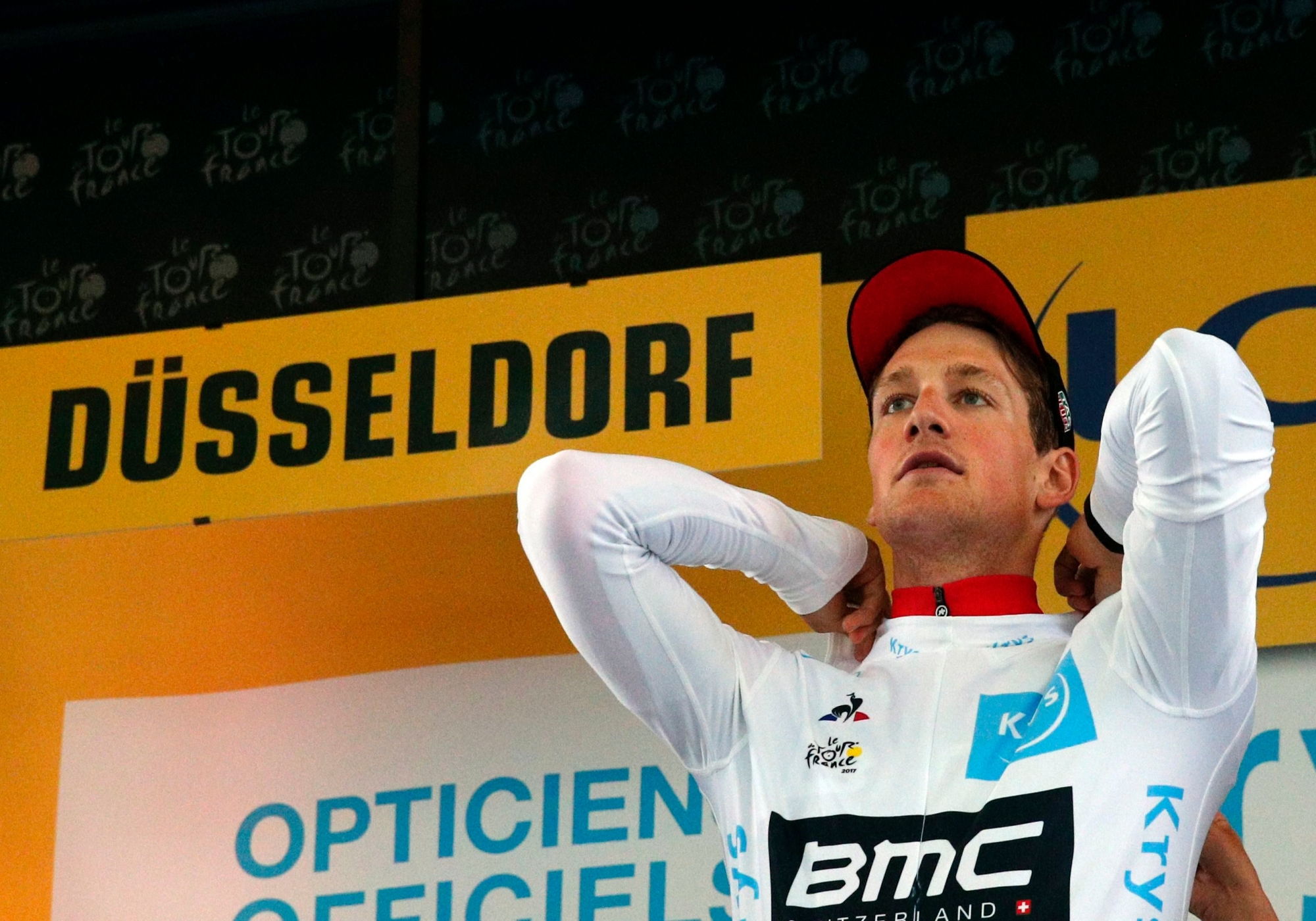 Switzerland's Stefan Kung puts on the best young rider's white jersey after the first stage of the Tour de France cycling race, an individual time trial over 14 kilometers (8,7 miles), with start and Finish in Duesseldorf, Germany, Saturday, July 1, 2017. (AP Photo/Christophe Ena) RAD TOUR DE FRANCE 2017