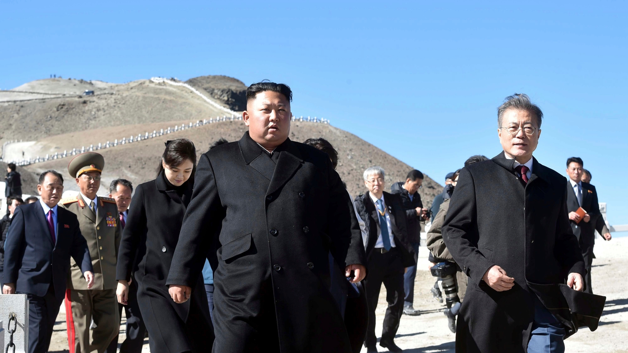 South Korean President Moon Jae-in, right, and North Korean leader Kim Jong Un, left, visit the Mount Paektu in North Korea, Thursday, Sept. 20, 2018. Moon and North Korean leader Kim Jong Un visited the picturesque and active volcano on the North Korean-Chinese border on Thursday and took a cable car to the crater lake called ÄúChonji" where they strolled together. (Pyongyang Press Corps Pool via AP) Koreas Summit Key Places