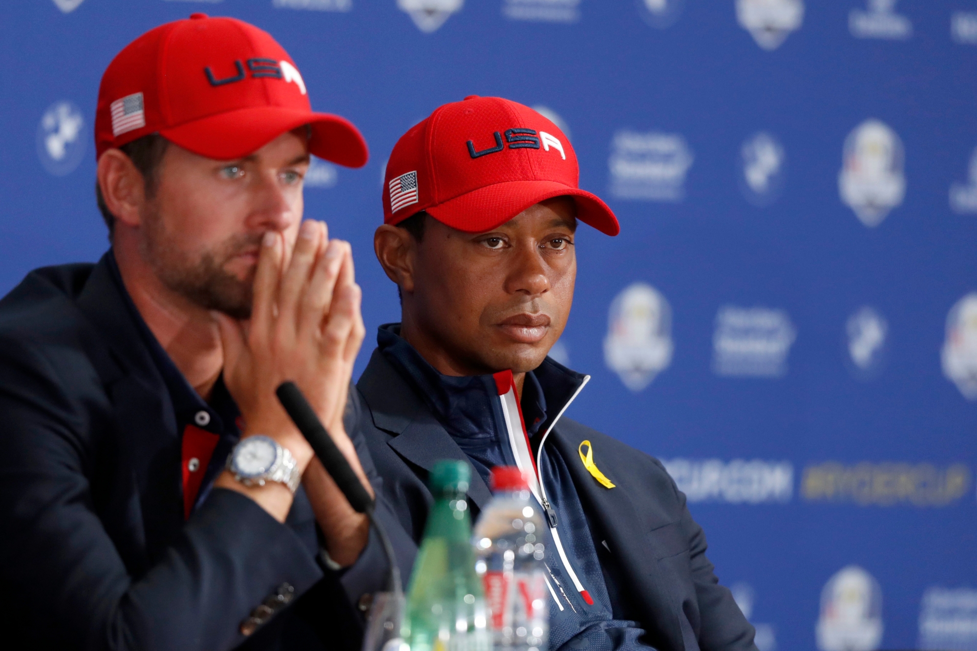 US players Webb Simpson, left, and Tiger Woods attend the press conference of the losing team after Europe won the 2018 Ryder Cup golf tournament at Le Golf National in Saint Quentin-en-Yvelines, outside Paris, France, Sunday, Sept. 30, 2018. (AP Photo/Alastair Grant) France Ryder Cup Golf