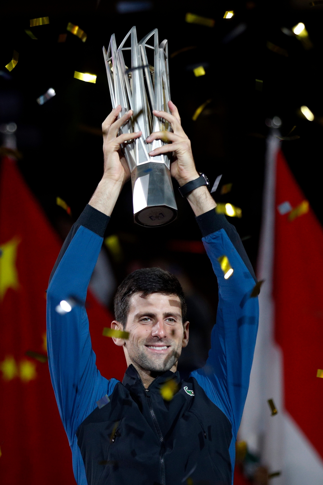 Novak Djokovic of Serbia holds up his trophy after defeating Borna Coric of Croatia in their men's singles final match to win the Shanghai Masters tennis tournament at Qizhong Forest Sports City Tennis Center in Shanghai, China, Sunday, Oct. 14, 2018. (AP Photo/Andy Wong) China Tennis Shanghai Masters